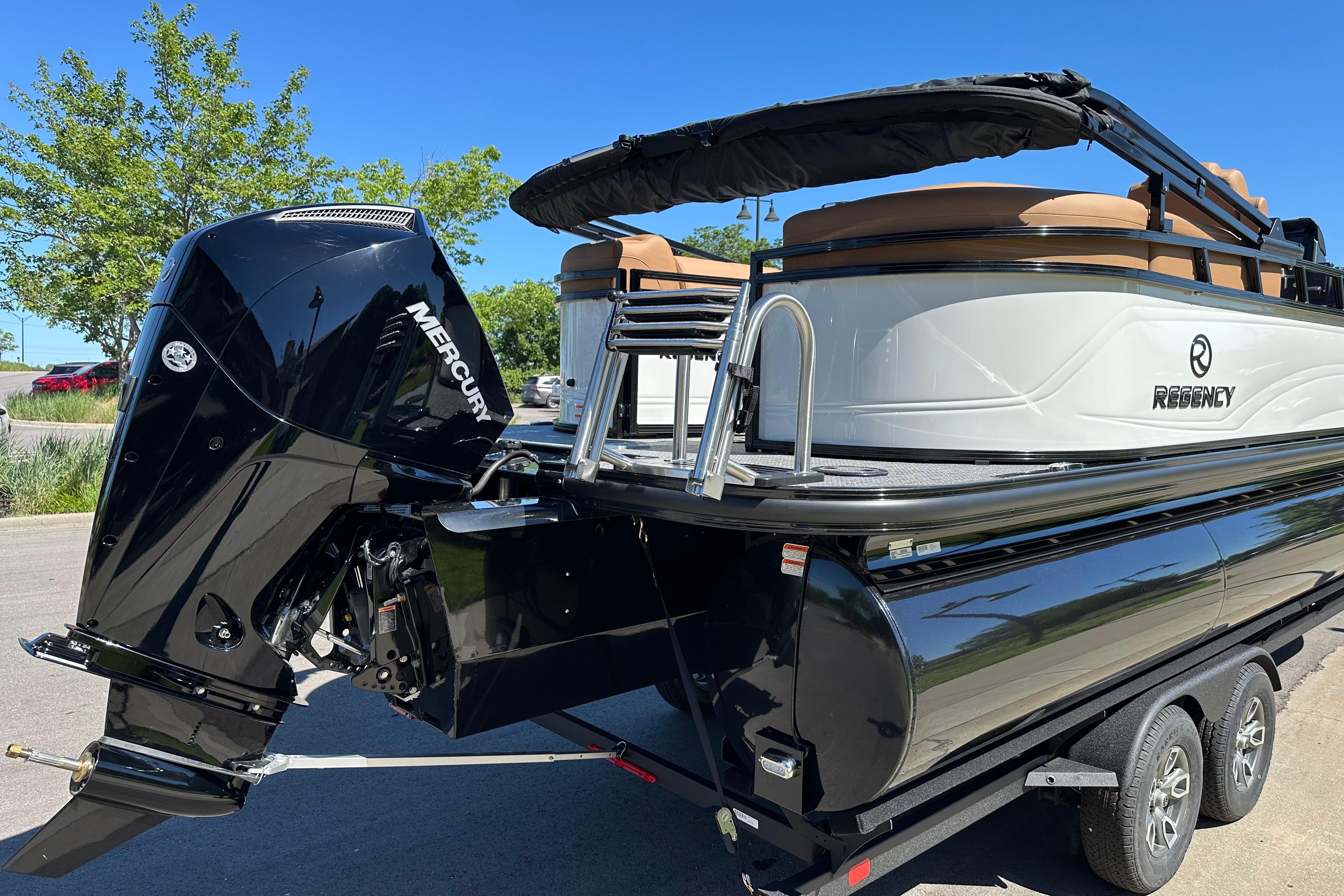 2026 Regency 230 DL pontoon boat with Mercury outboard motor, parked on a trailer.