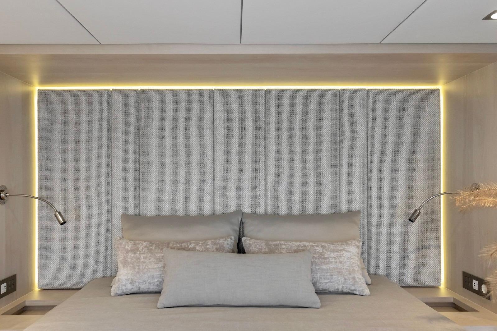 Luxurious Sunreef 60 yacht bedroom with modern lighting and elegant gray decor, 2023 model.