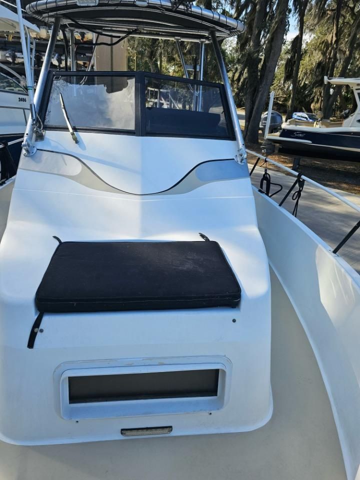 1991 Pro-Line Cuddy Cabin boat with white deck and black seat cushion.