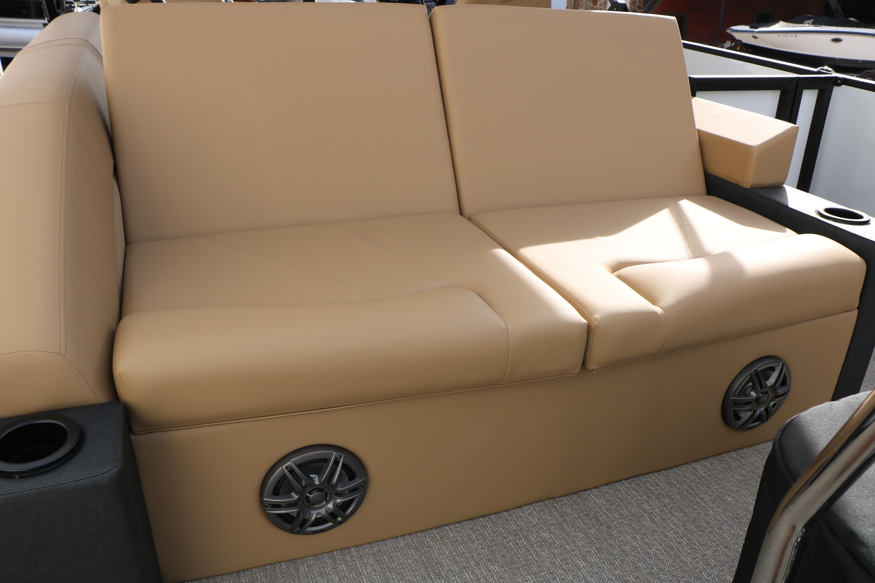 Beige seating on 2026 Evotti 523CS boat with built-in speakers and cup holders.