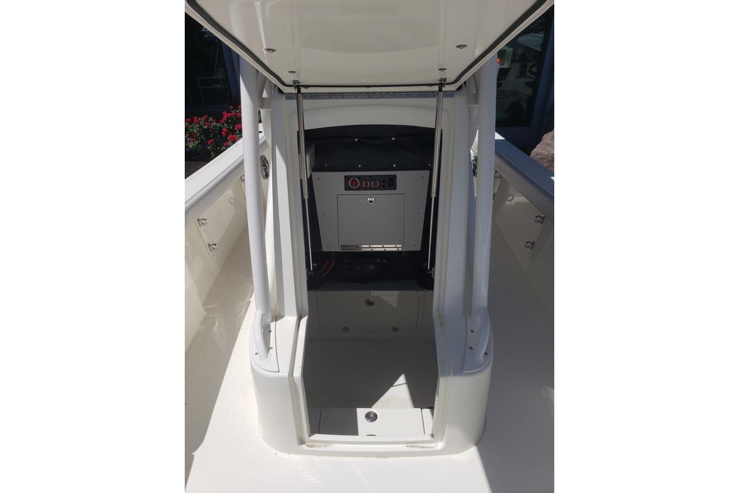 2026 Mako 226 Center Console boat interior with open storage compartment.