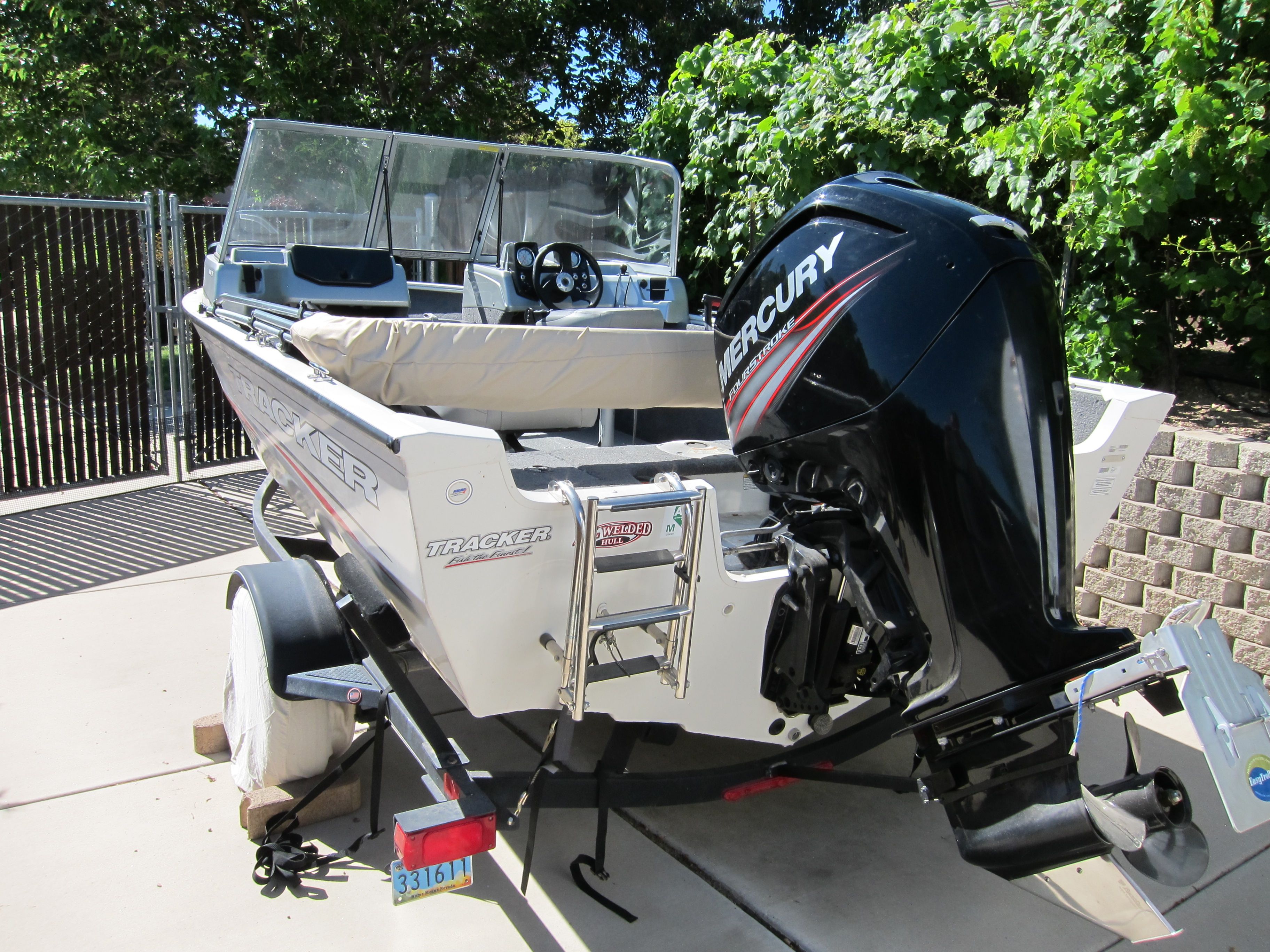 A 2018 Tracker Pro Guide V-16 WT boat on a trailer, featuring a Mercury outboard motor.