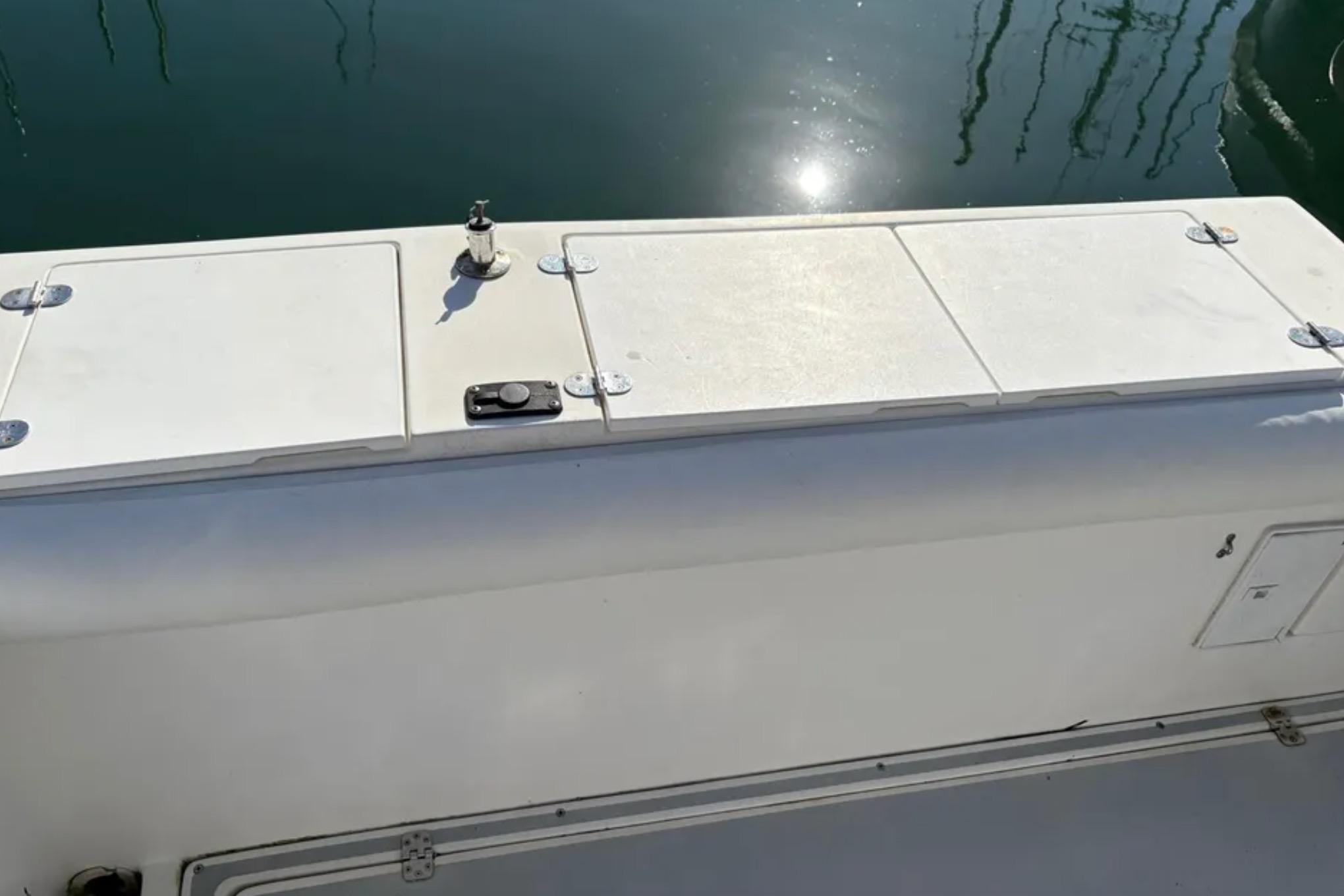 2005 Albin 28 Tournament Express boat deck with storage compartments and cleat.