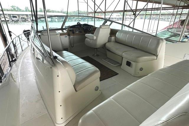 2004 Carver 360 Mariner interior with spacious seating and helm, docked in a marina.