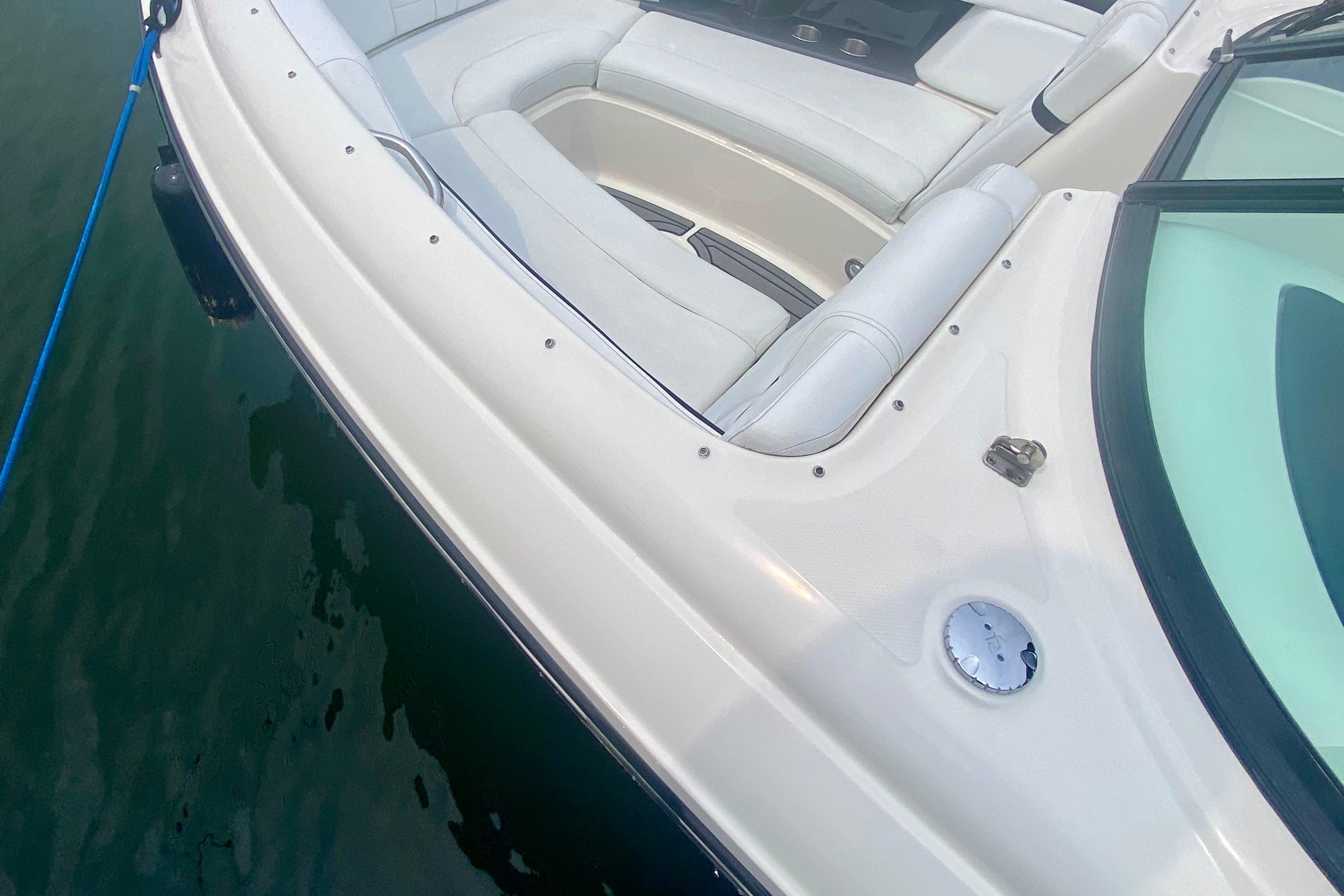 2015 Sea Ray 250 SLX boat with white seating and sleek design on water.