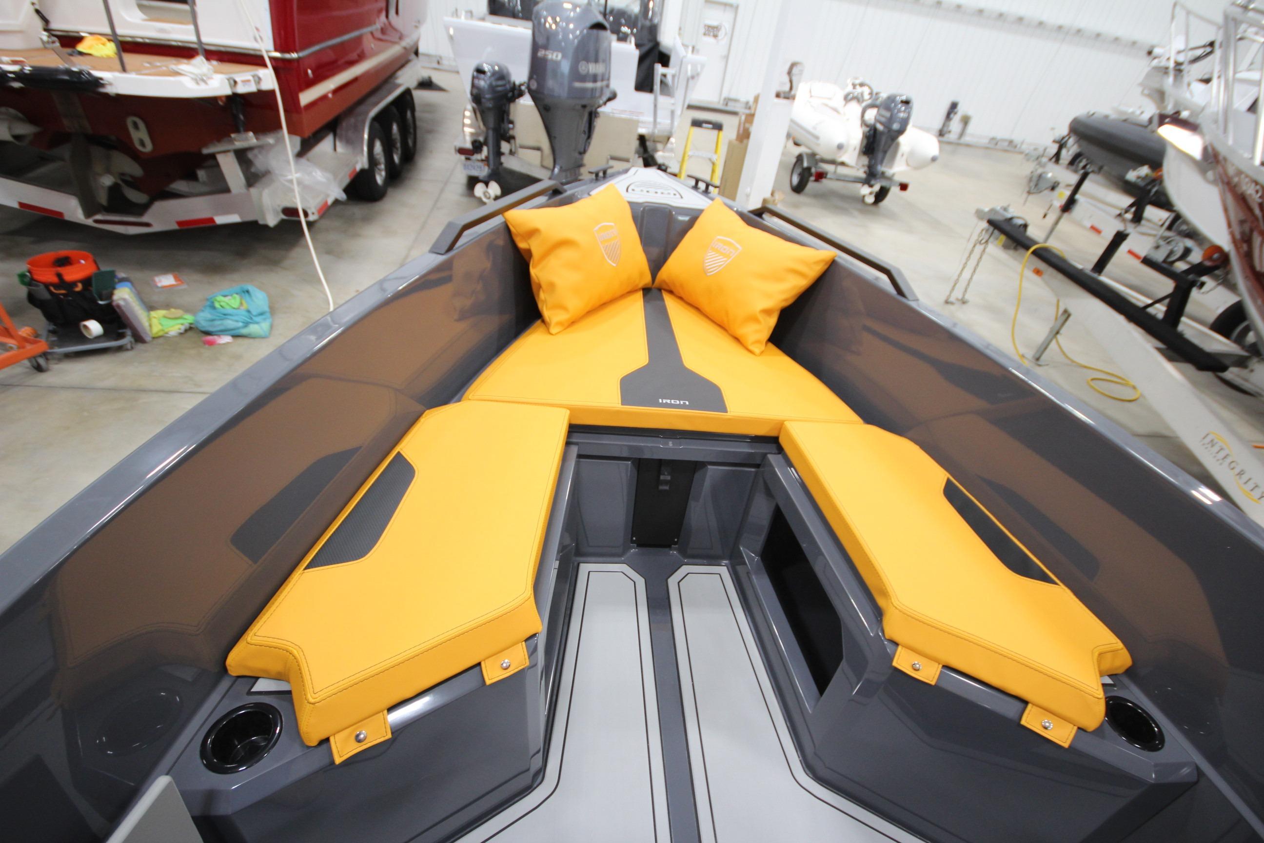 2026 IRON BOATS IRON 767 with vibrant yellow seating in a showroom.