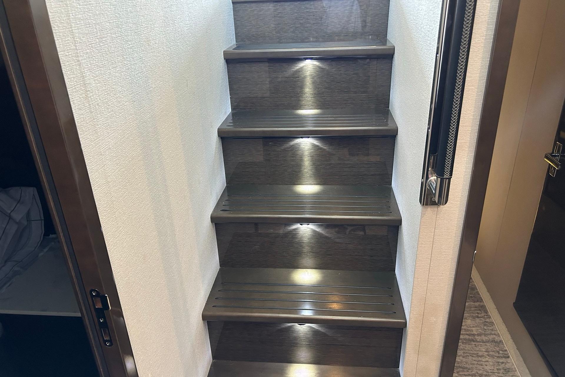 Staircase with ambient lighting inside 2021 Cruisers Yachts 50 Cantius.