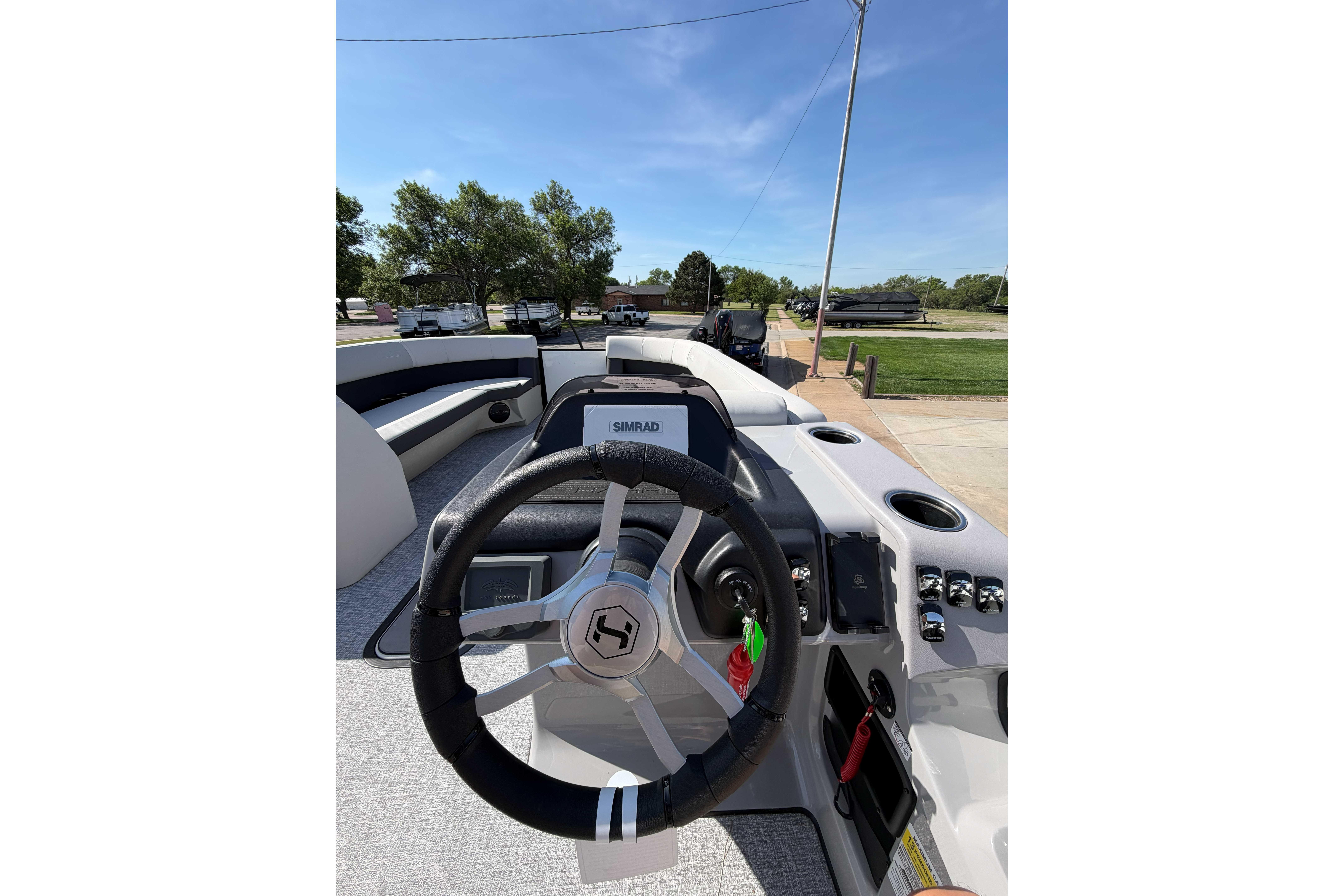 2025 Harris Cruiser 250 boat dashboard with steering wheel and control panel.