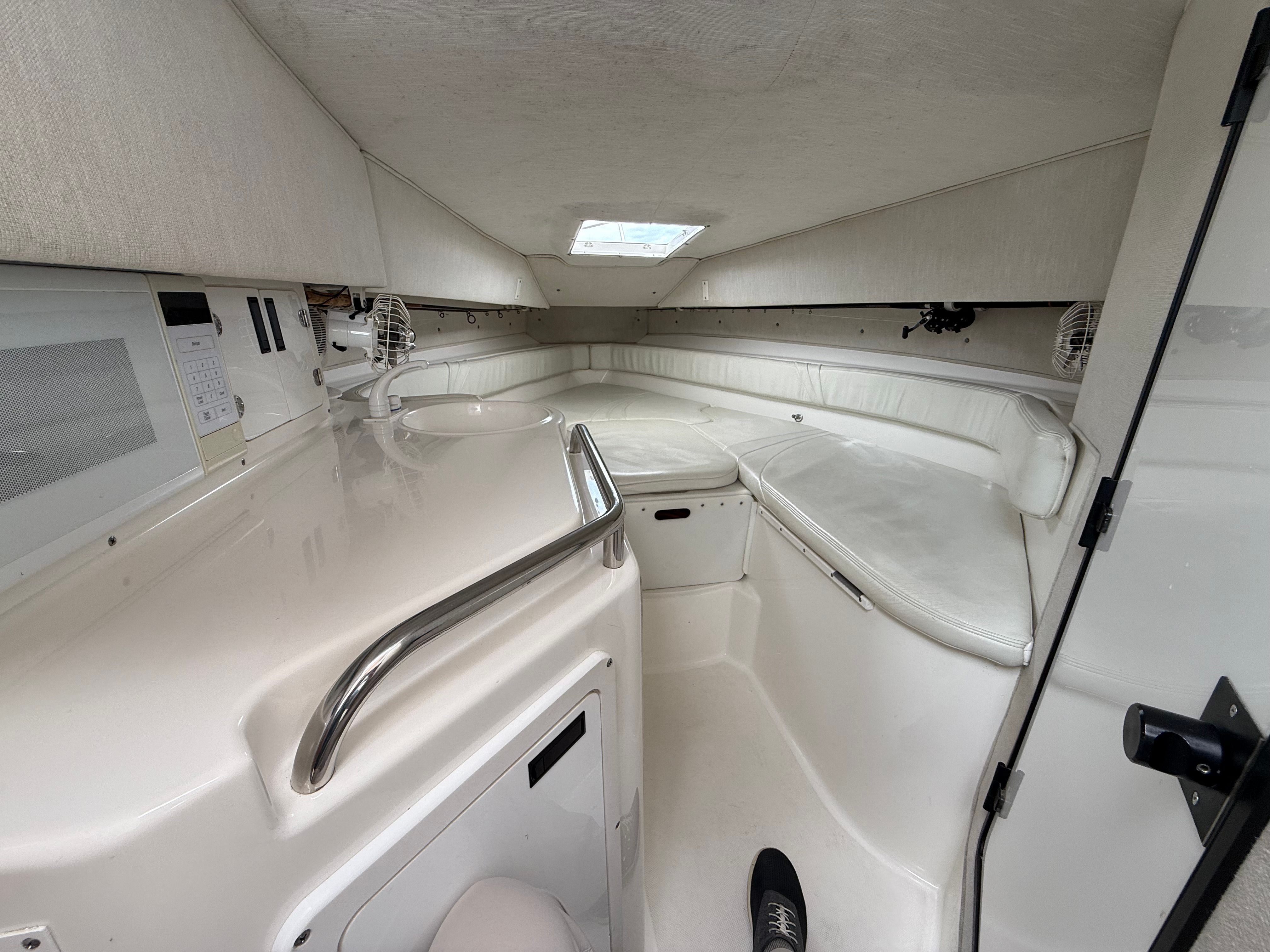 Interior of a 1999 Fountain 32 Sport Fish Cruiser, white cabin.
