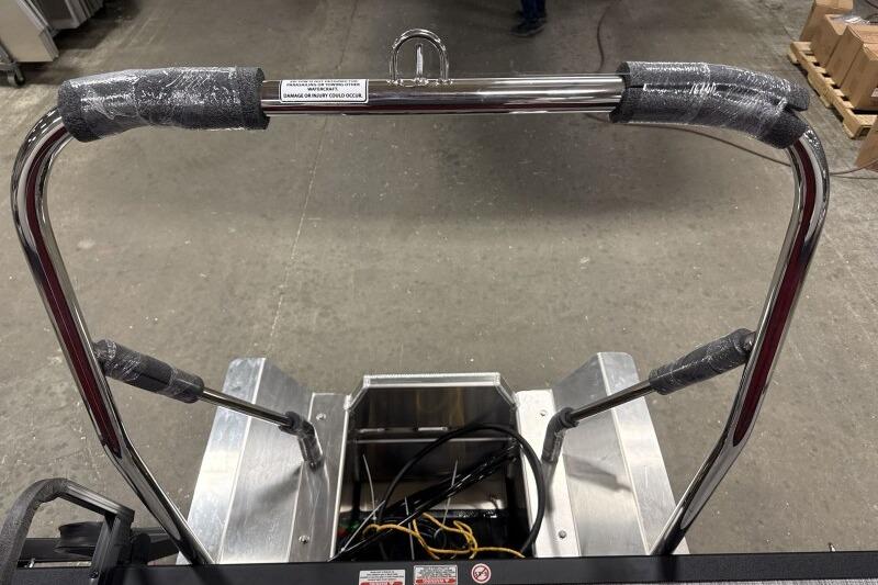 2026 Bennington 22 SSRSF boat ladder with protective wrapping in a workshop setting.
