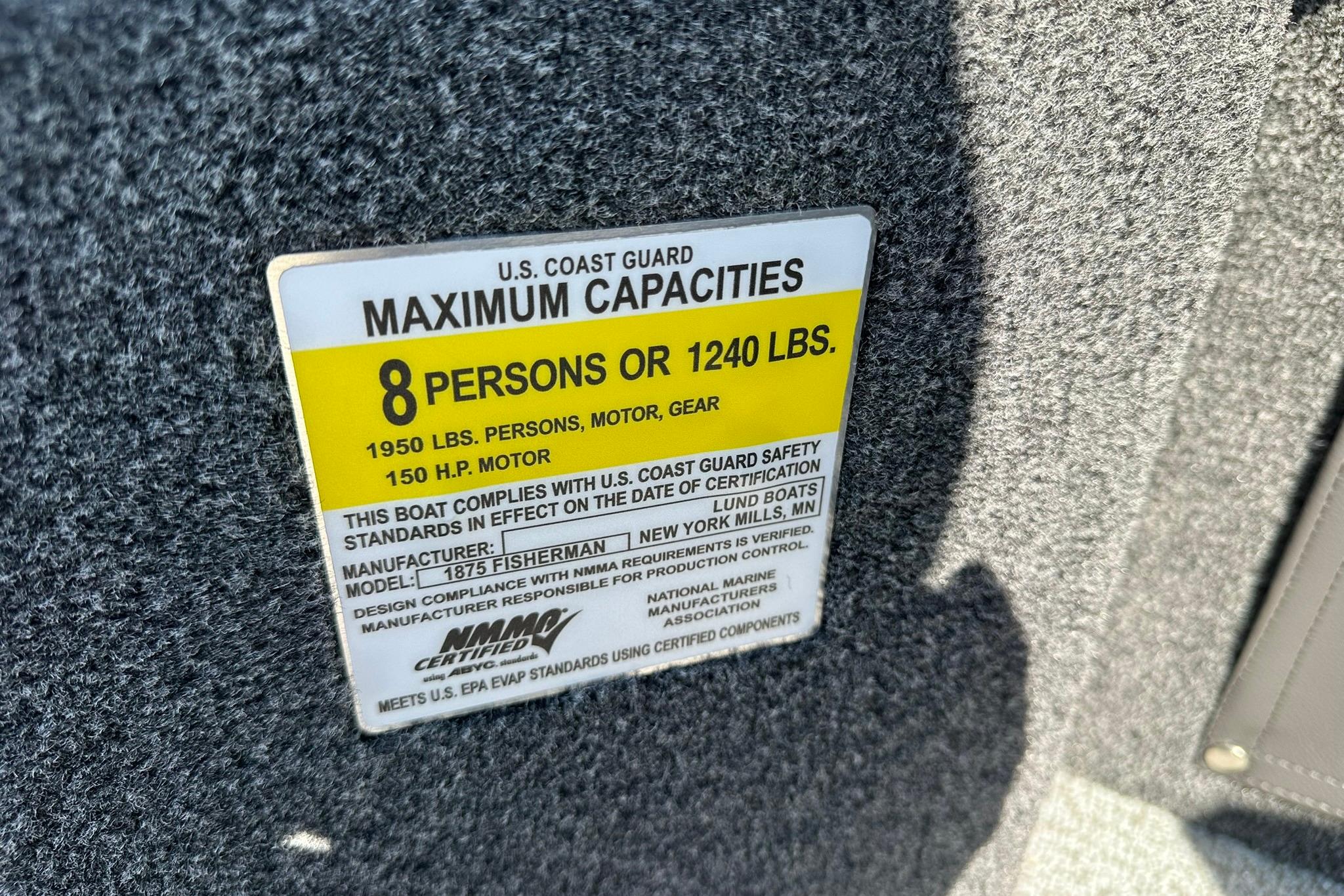 2026 Lund 1875 Fisherman capacity label, 8 persons or 1240 lbs, 150 HP motor.