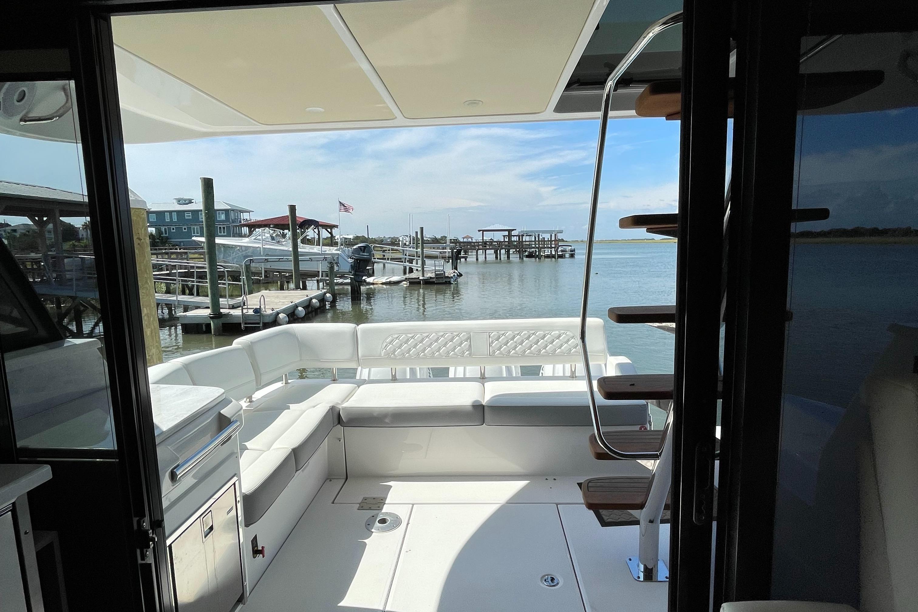 2022 Regal 42 FXO yacht interior with waterfront view and seating area.