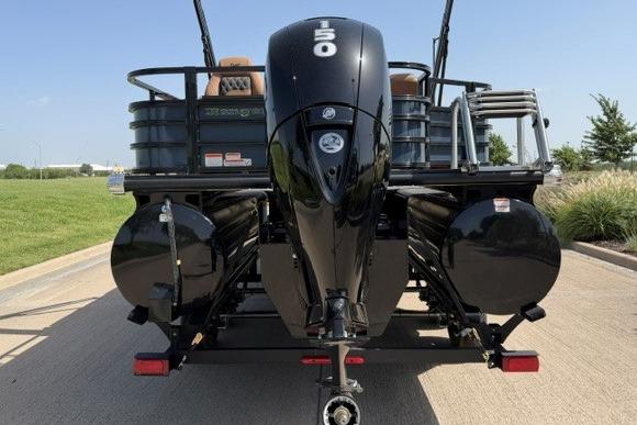 2026 Ranger 223F boat with powerful 150 HP outboard motor, parked on a sunny day.