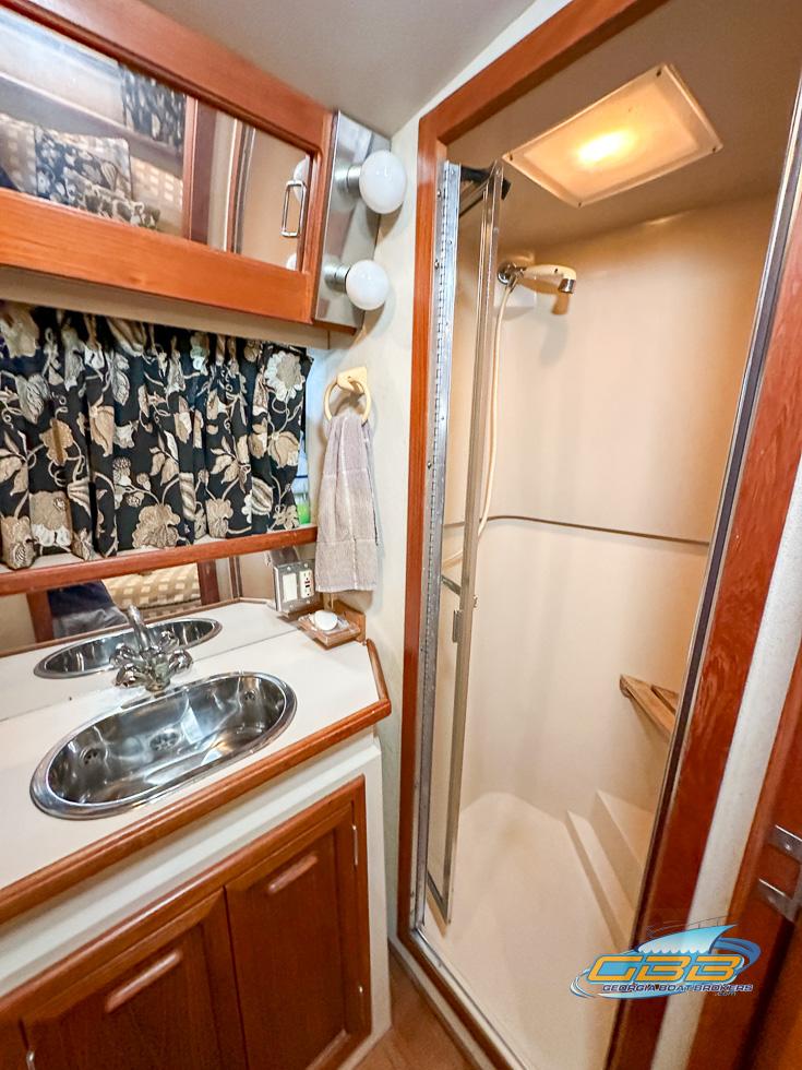 1989 Carver 3807 Aft Cabin bathroom with shower and dual sinks.