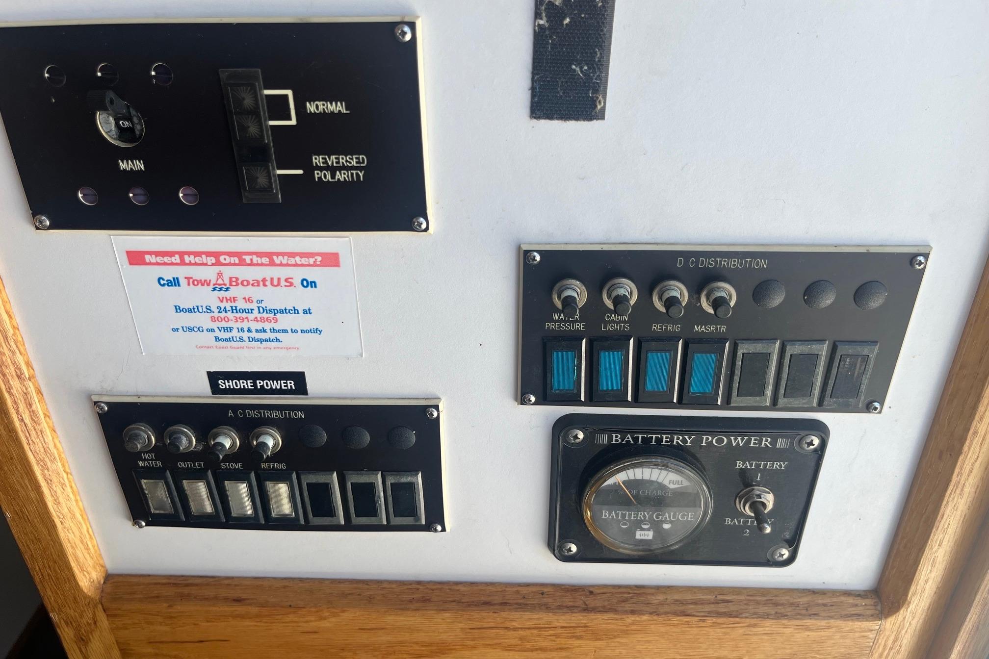 Control panel of a 1988 Seafox 29 Flybridge boat with various switches and gauges.