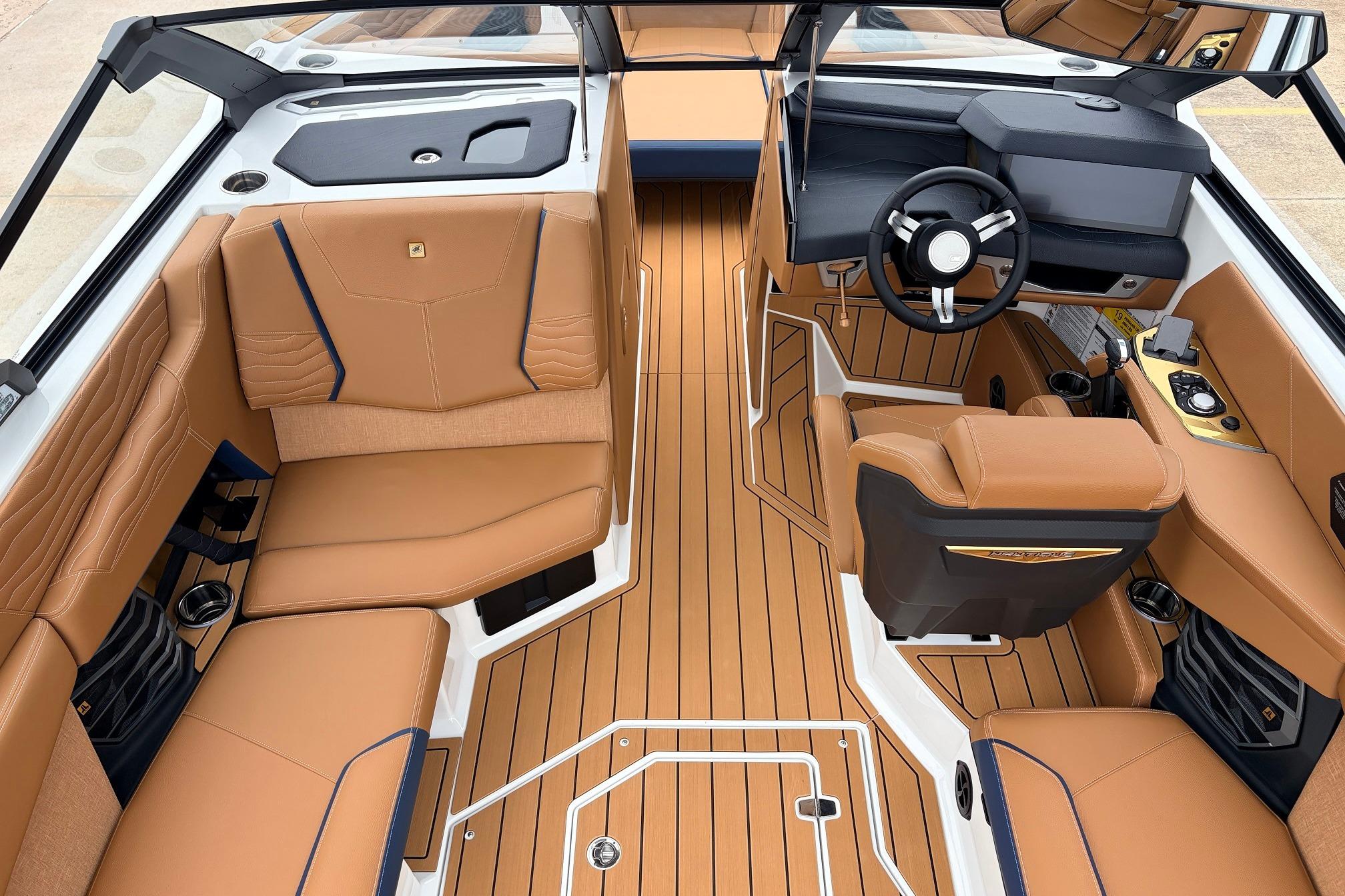 Luxurious interior of 2026 Nautique Super Air Nautique G25 with tan leather seating and sleek design.