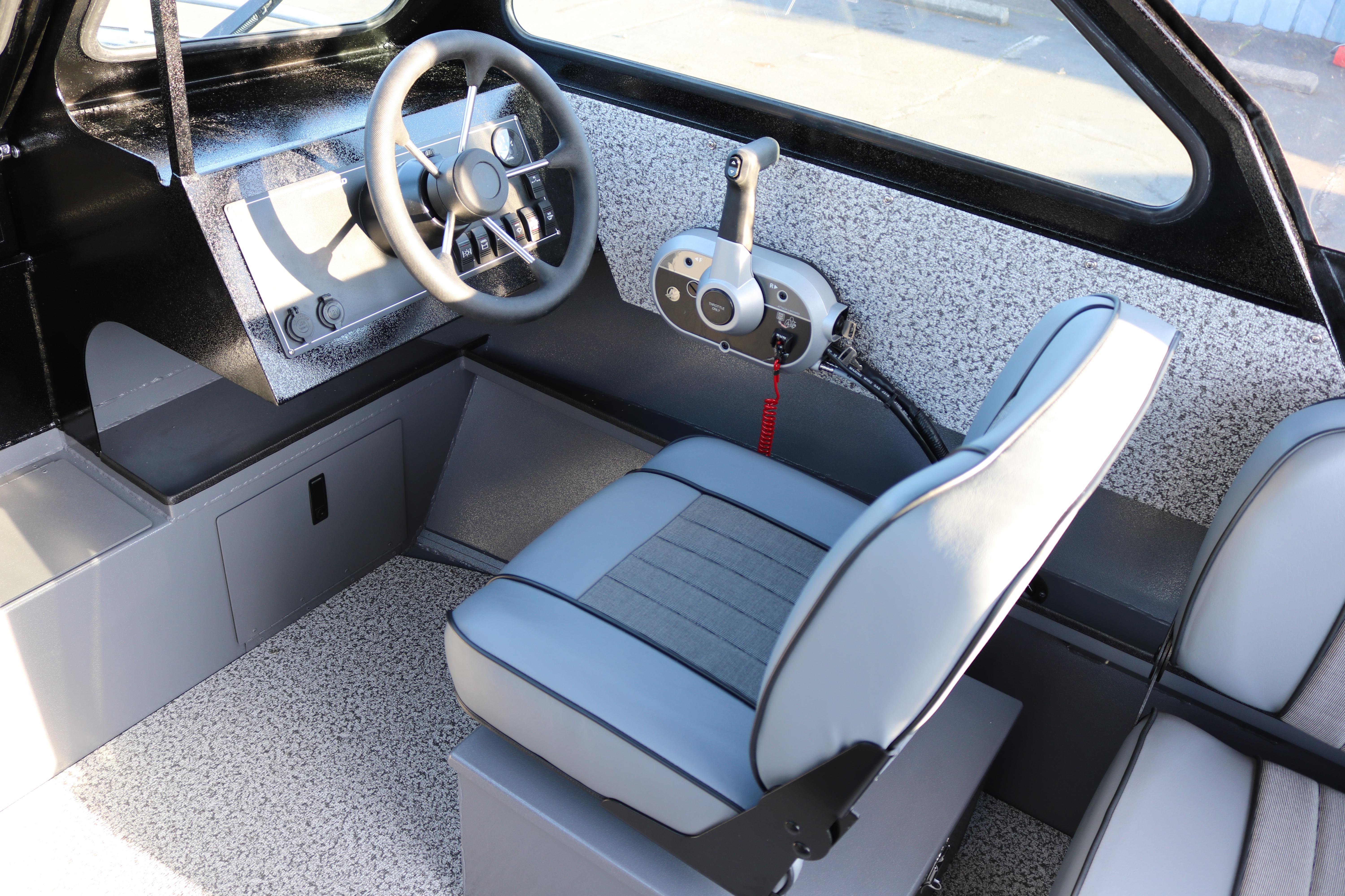 Interior of 2026 Alumaweld Stryker X202 boat with modern steering and seating.