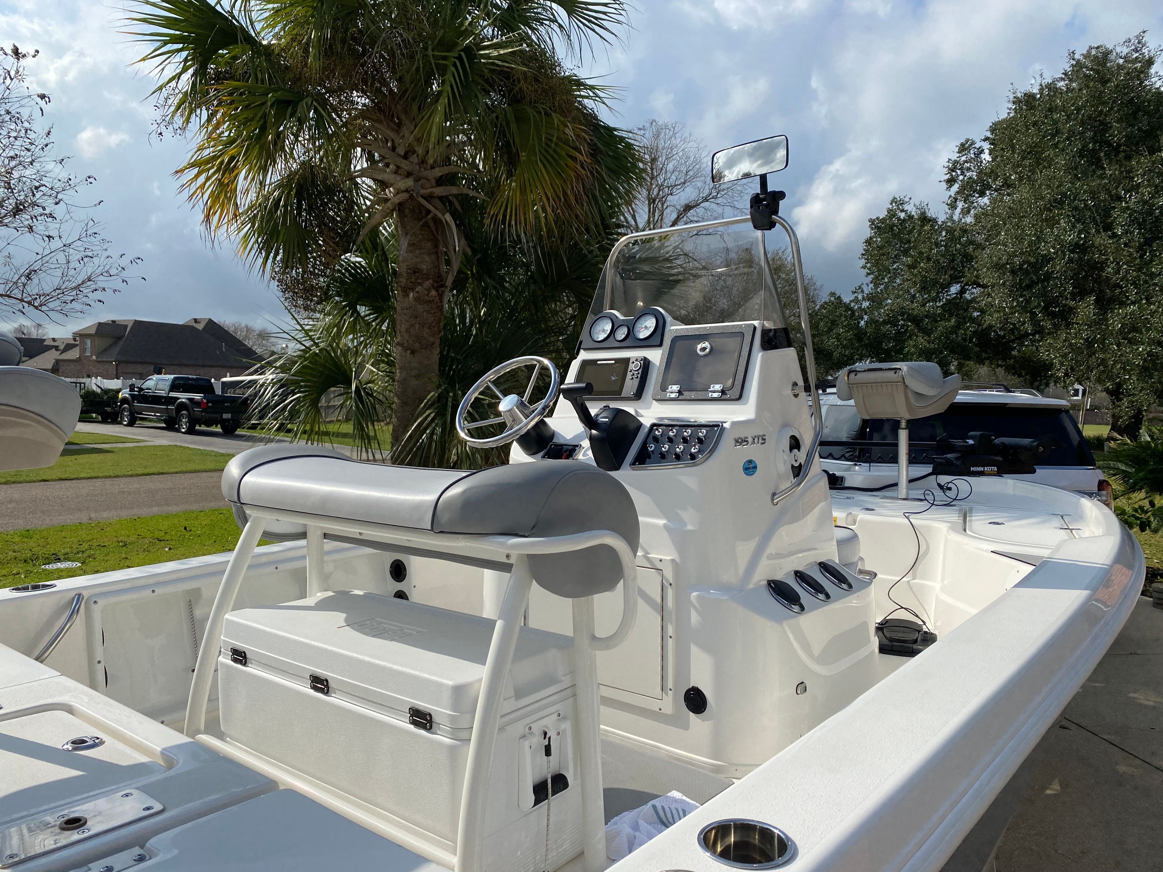 The image shows a 2021 NauticStar 195 XTS boat with a helm and seating bench.