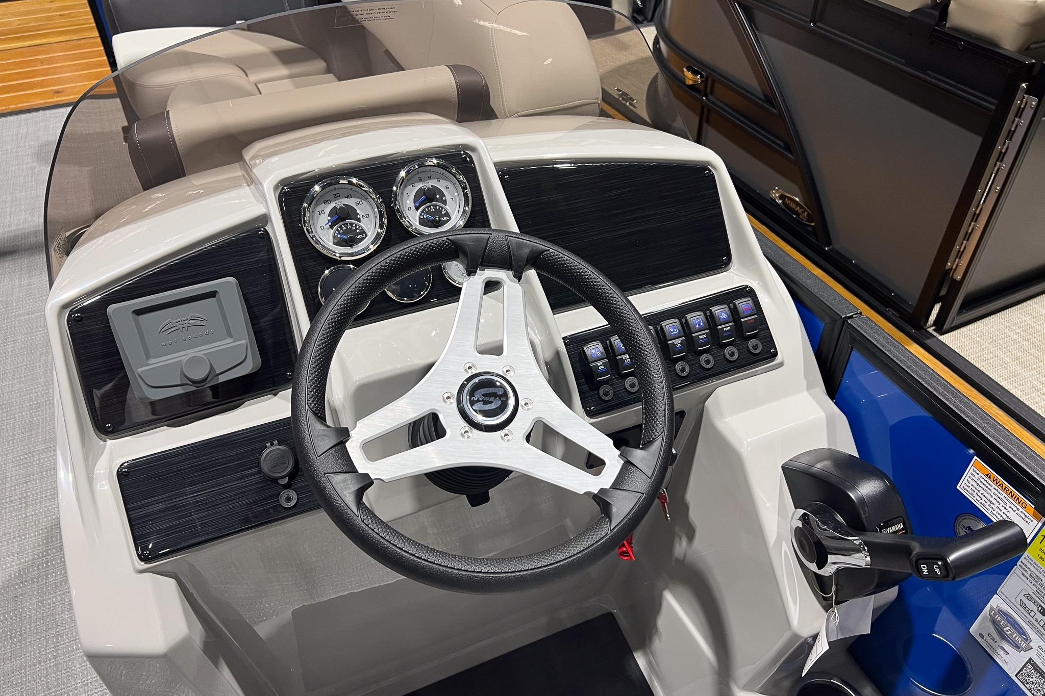 2026 Sylvan Mirage 822 CLZ boat dashboard with steering wheel and control panel.