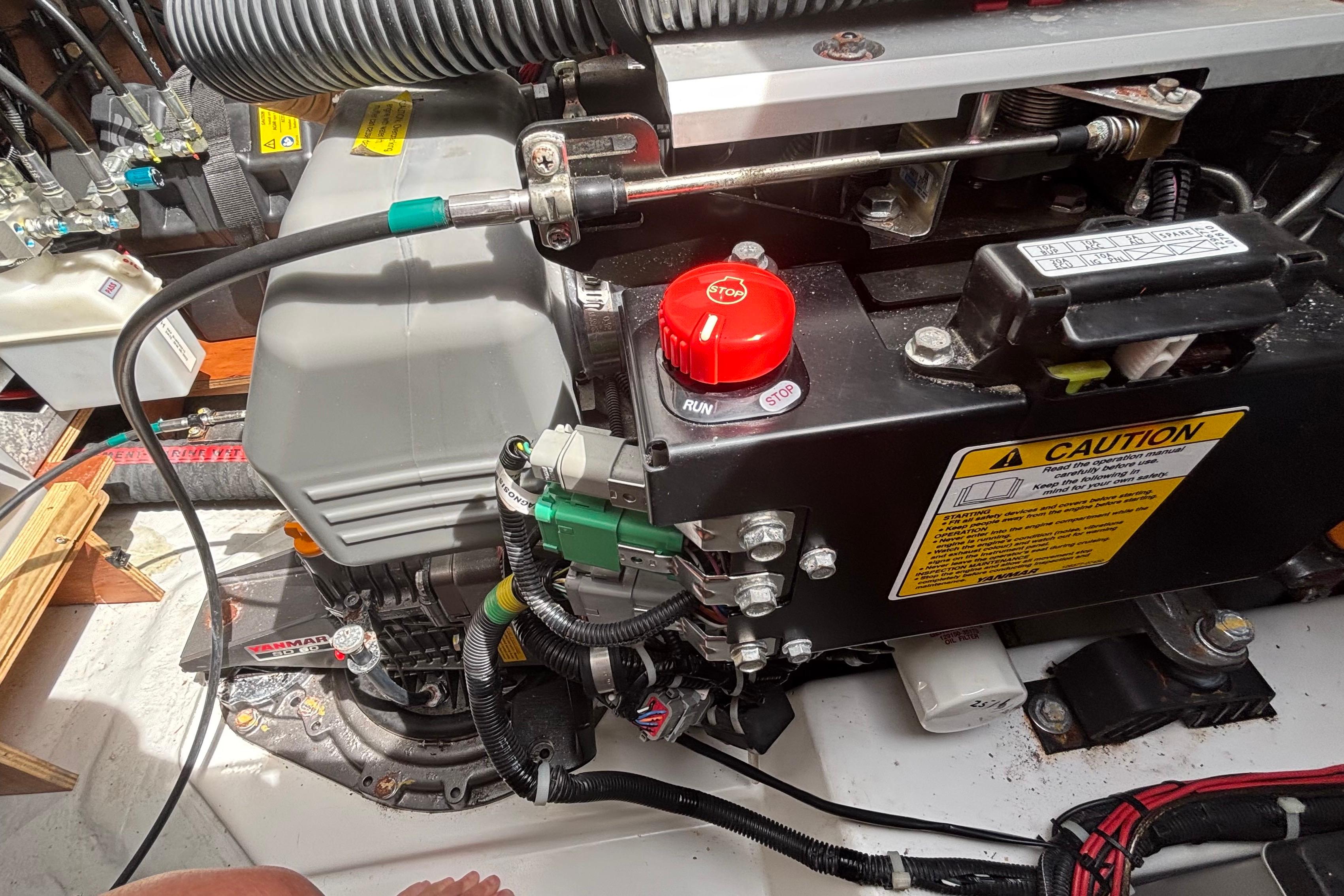 Engine compartment of a 2023 Lagoon 46 yacht, featuring detailed mechanical components.