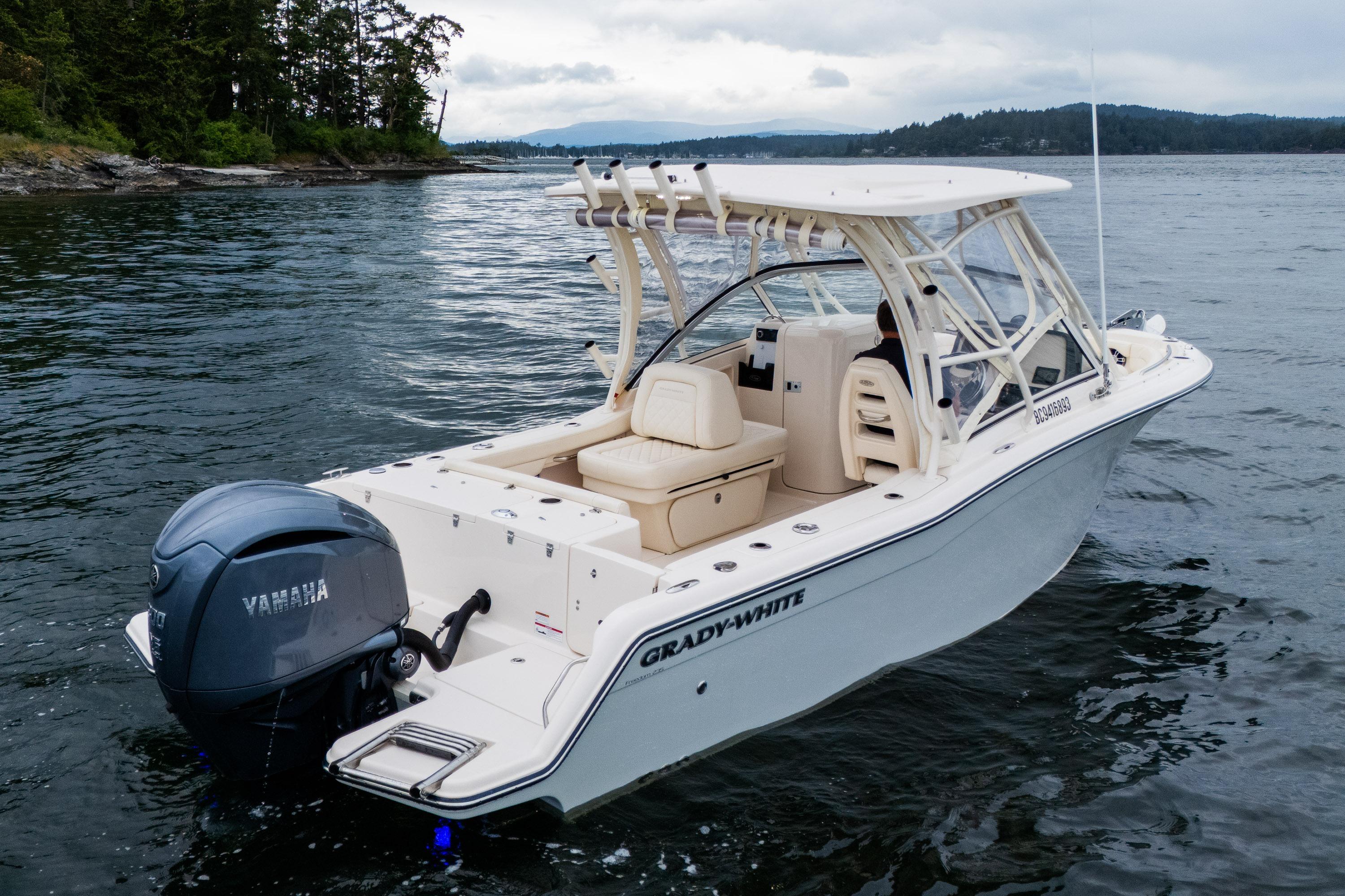 2023 Grady-White Freedom 235 boat with Yamaha engine on scenic water.