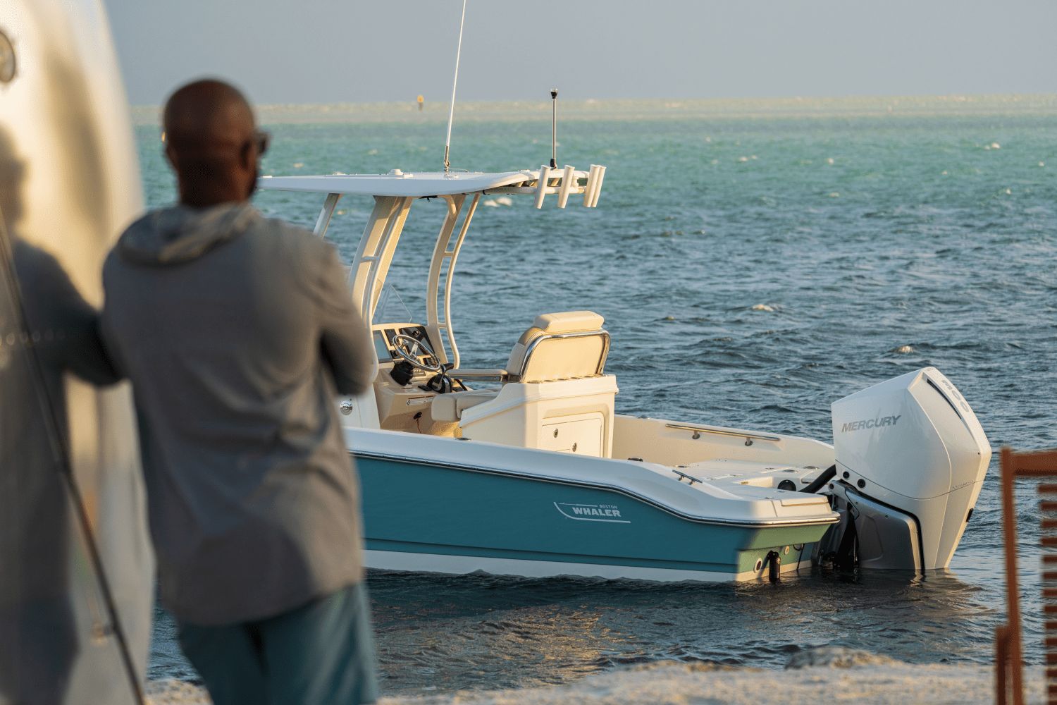 A Boston Whaler 25DA boat on the water with a Mercury outboard motor.