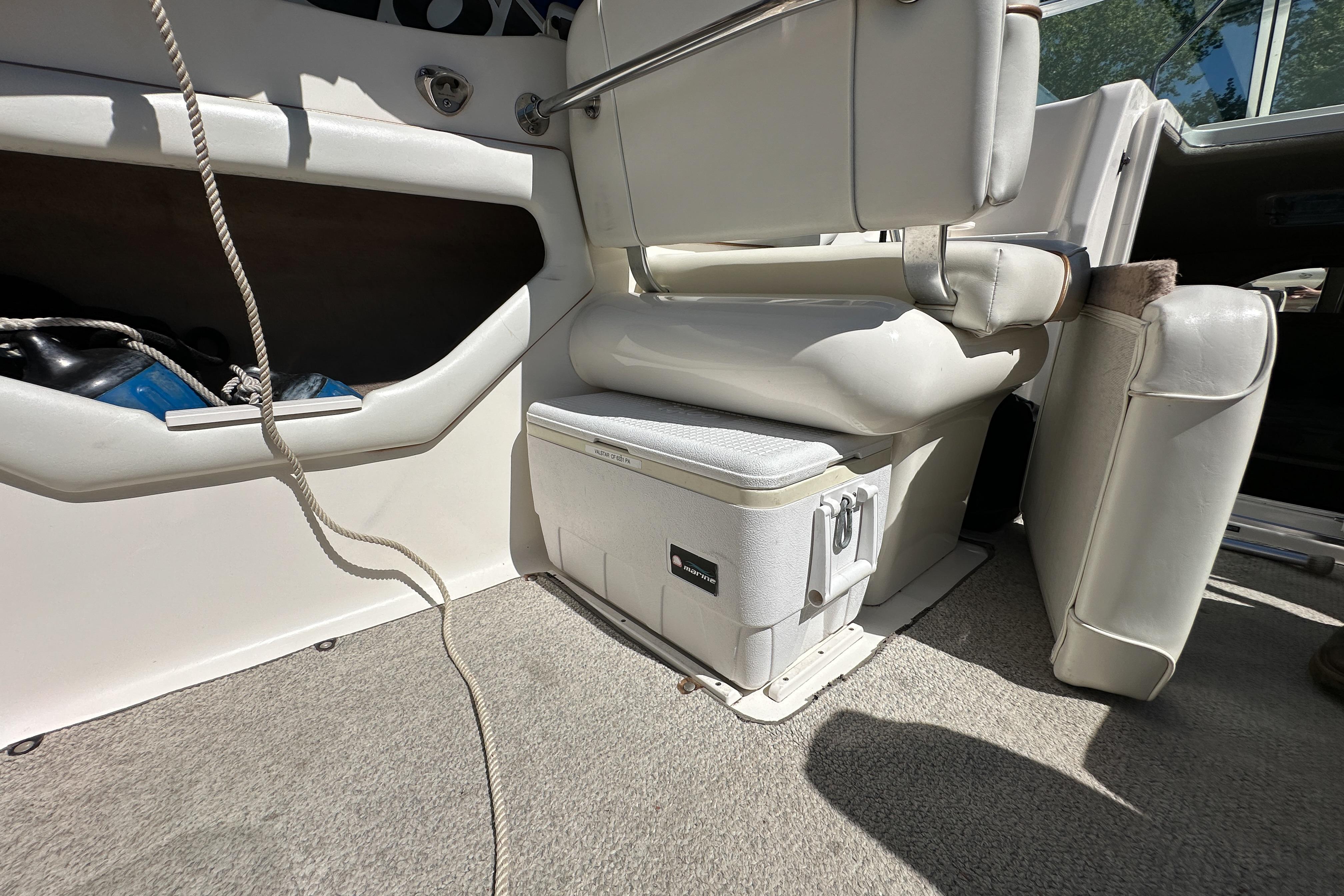 1998 Sea Ray 215 Express Cruiser interior with seating and storage compartment.