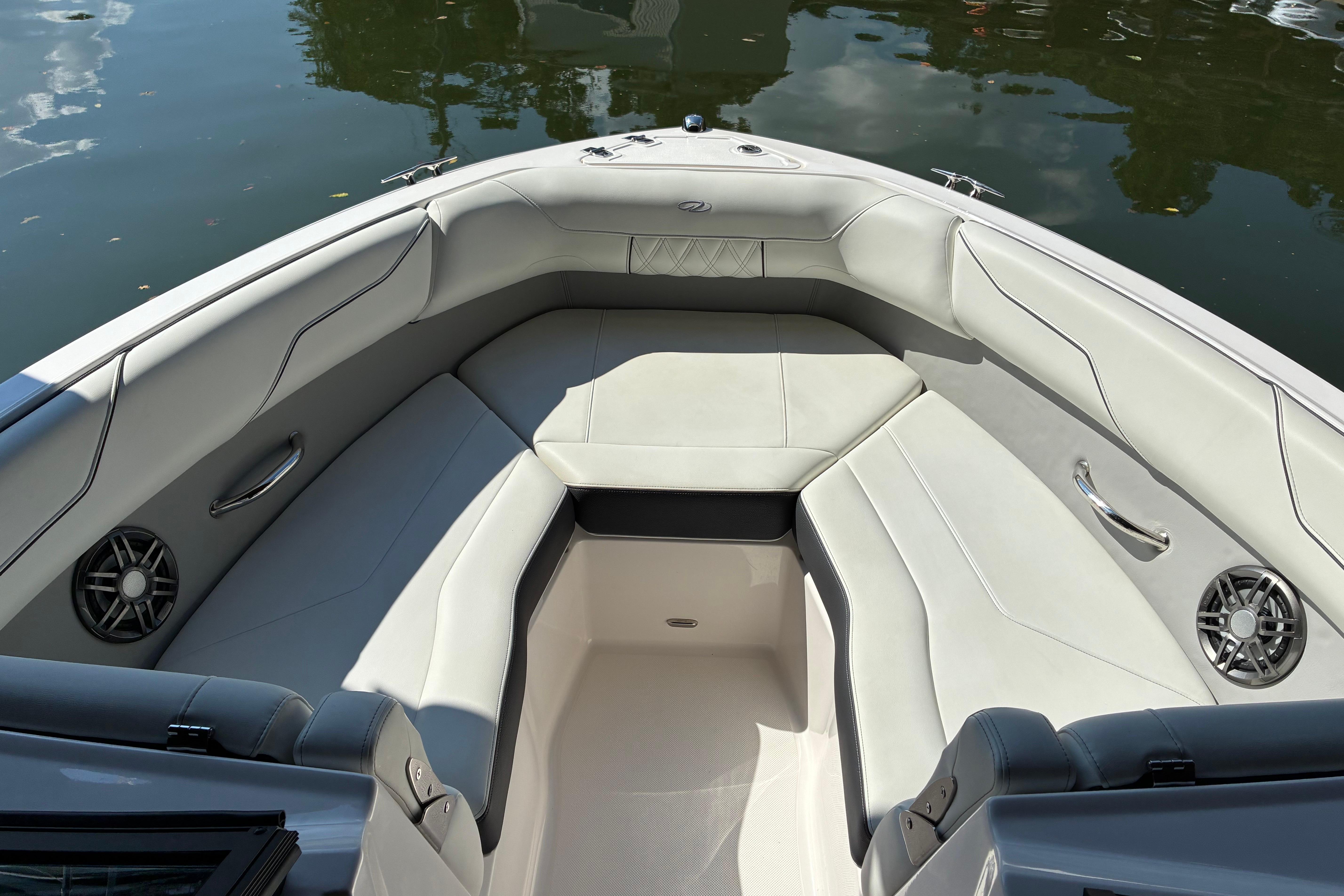 Luxurious interior of 2025 Regal LS2 boat with plush seating and speakers.