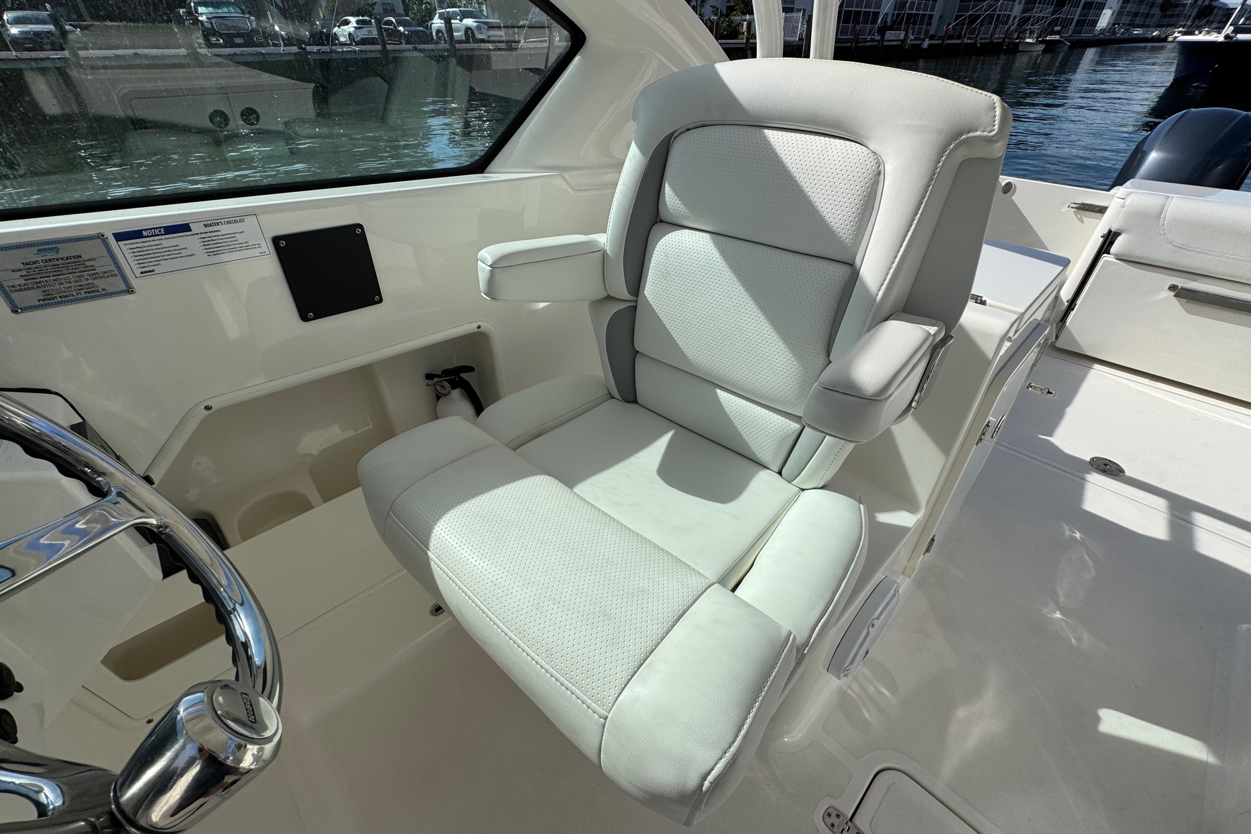 Captain's seat on 2022 Pursuit DC 266 Dual Console boat, featuring sleek design and comfort.