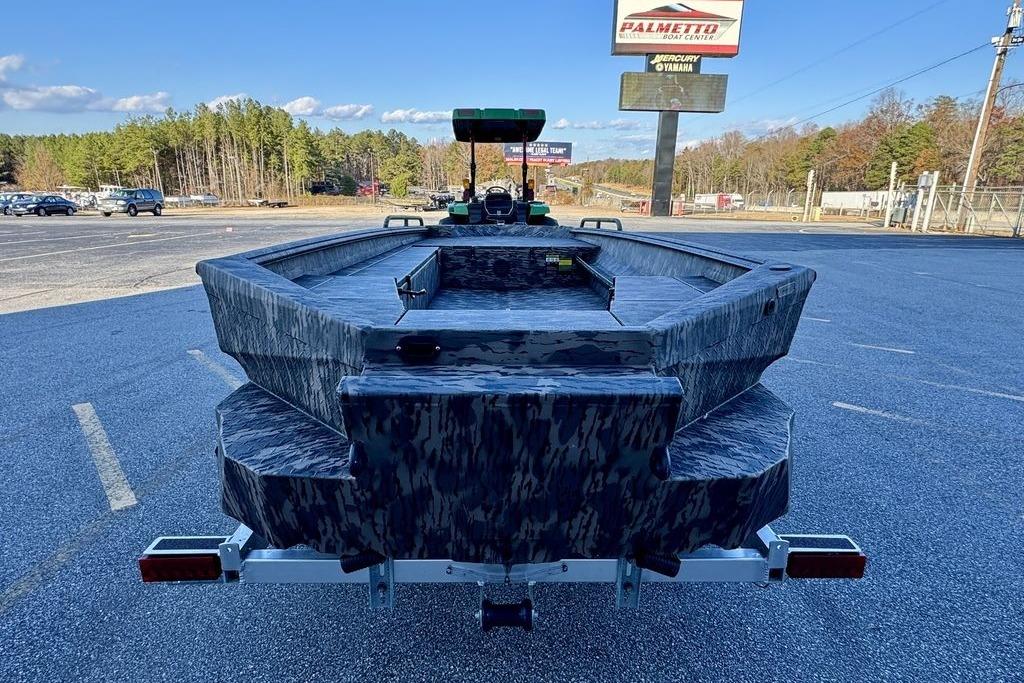 2026 Havoc 1756 boat in parking lot, camo design, clear sky background.