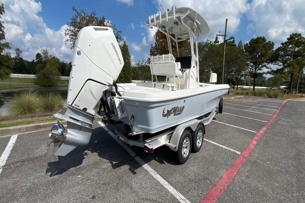 2026 Mako 24 APEX boat on trailer in parking lot, sunny day.