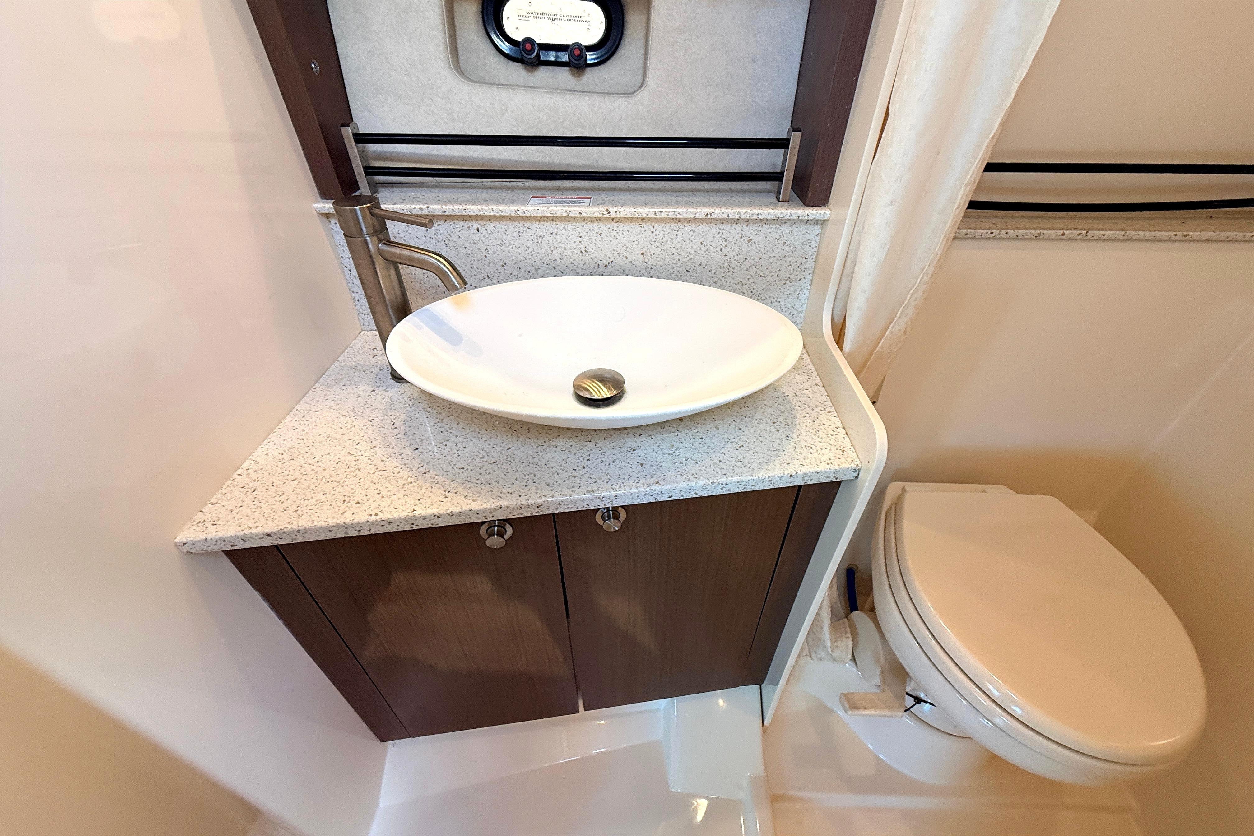 2013 Sea Ray 370 Venture bathroom with modern sink and toilet.