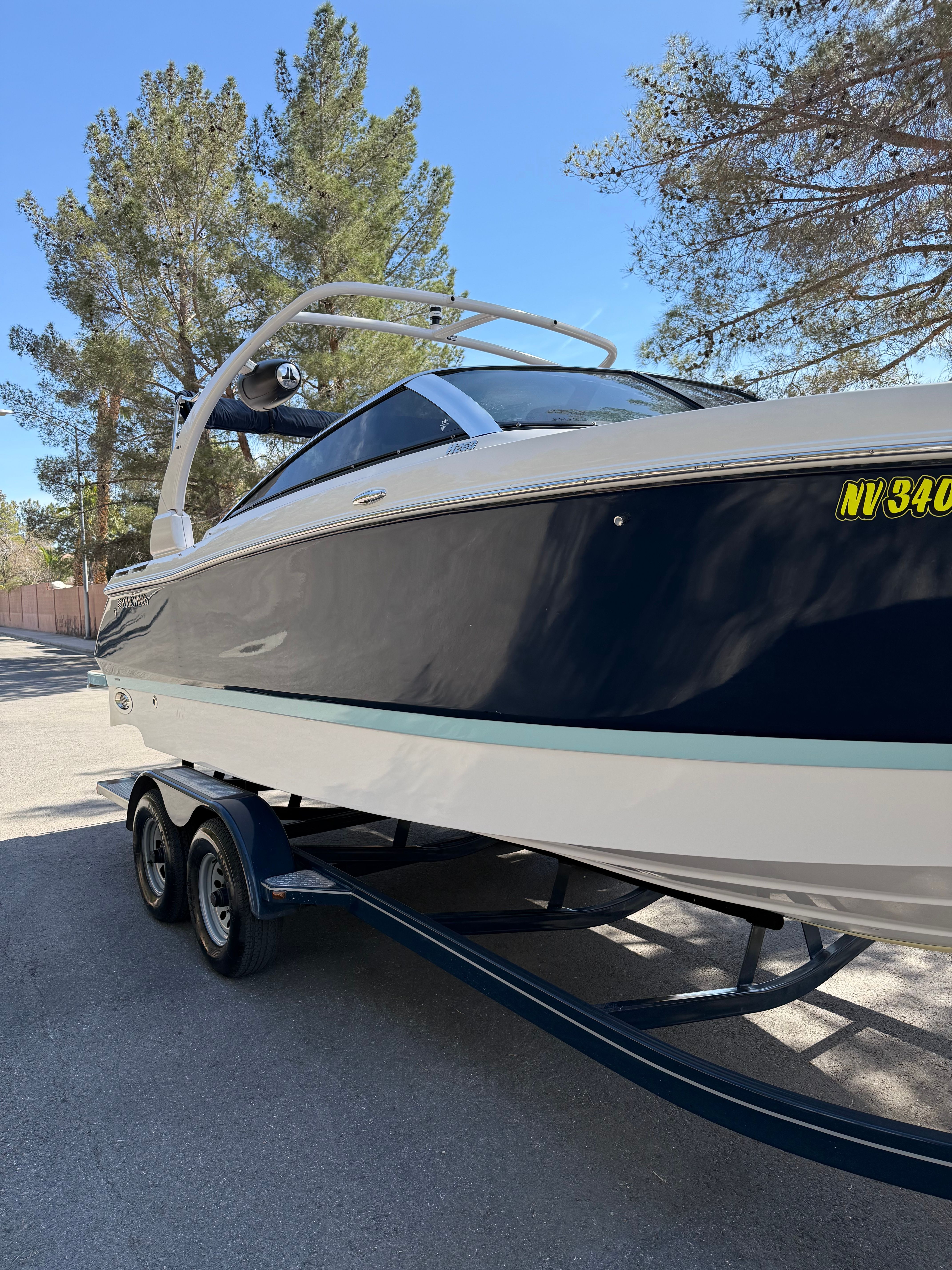 2019 Four Winns H260 boat on trailer, side view.
