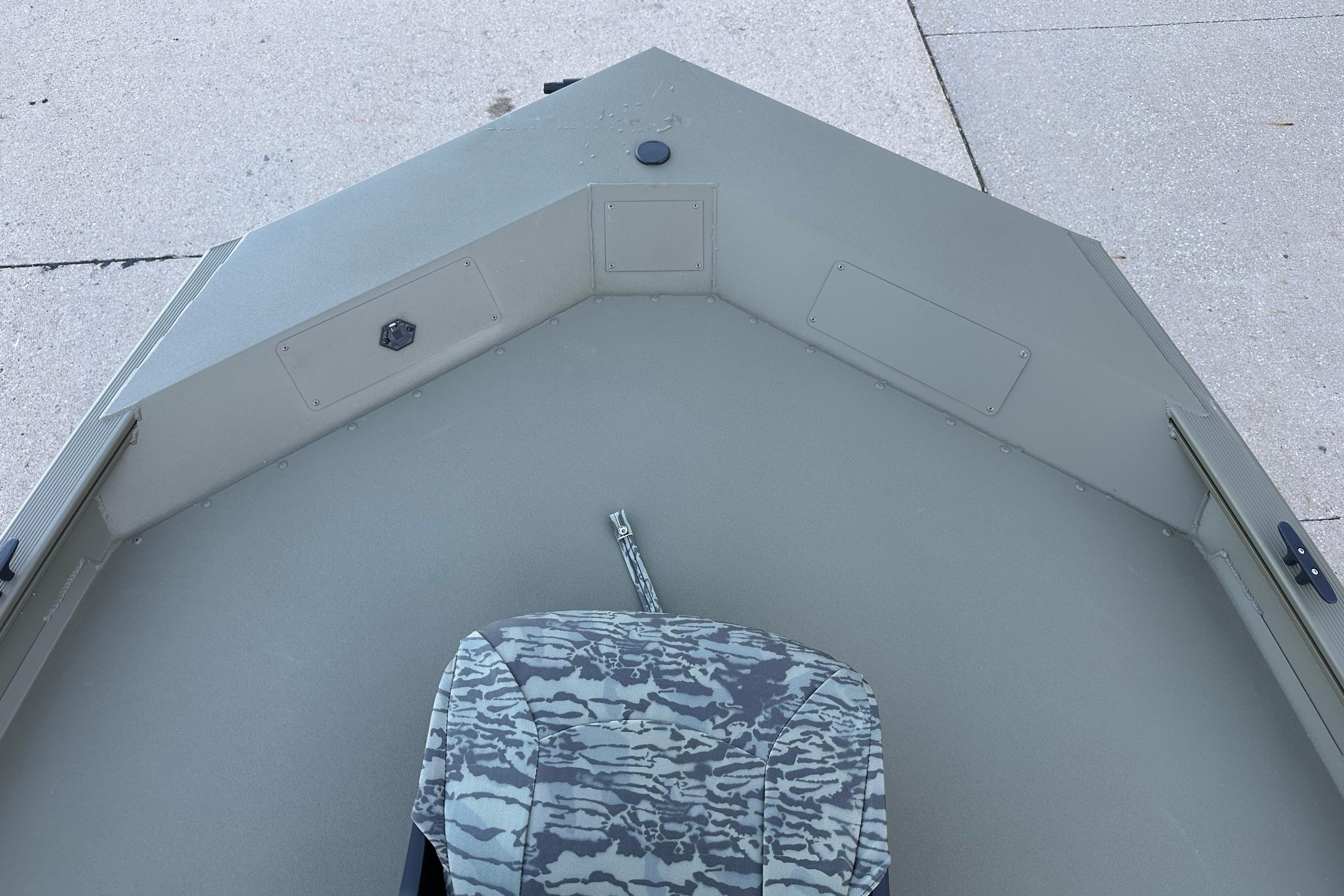 2026 Tracker Grizzly 1754 SC boat interior with camouflage seat and storage compartments.