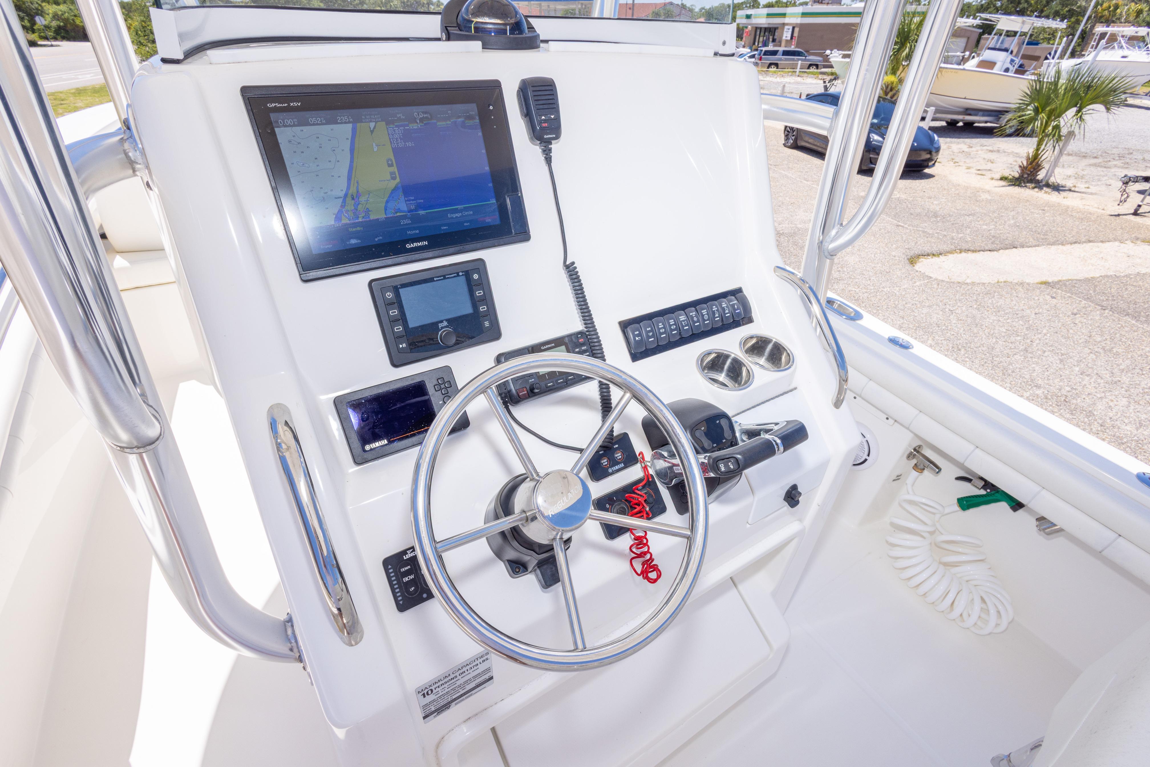 2019 Regulator 23 Center Console helm with navigation equipment and steering wheel.