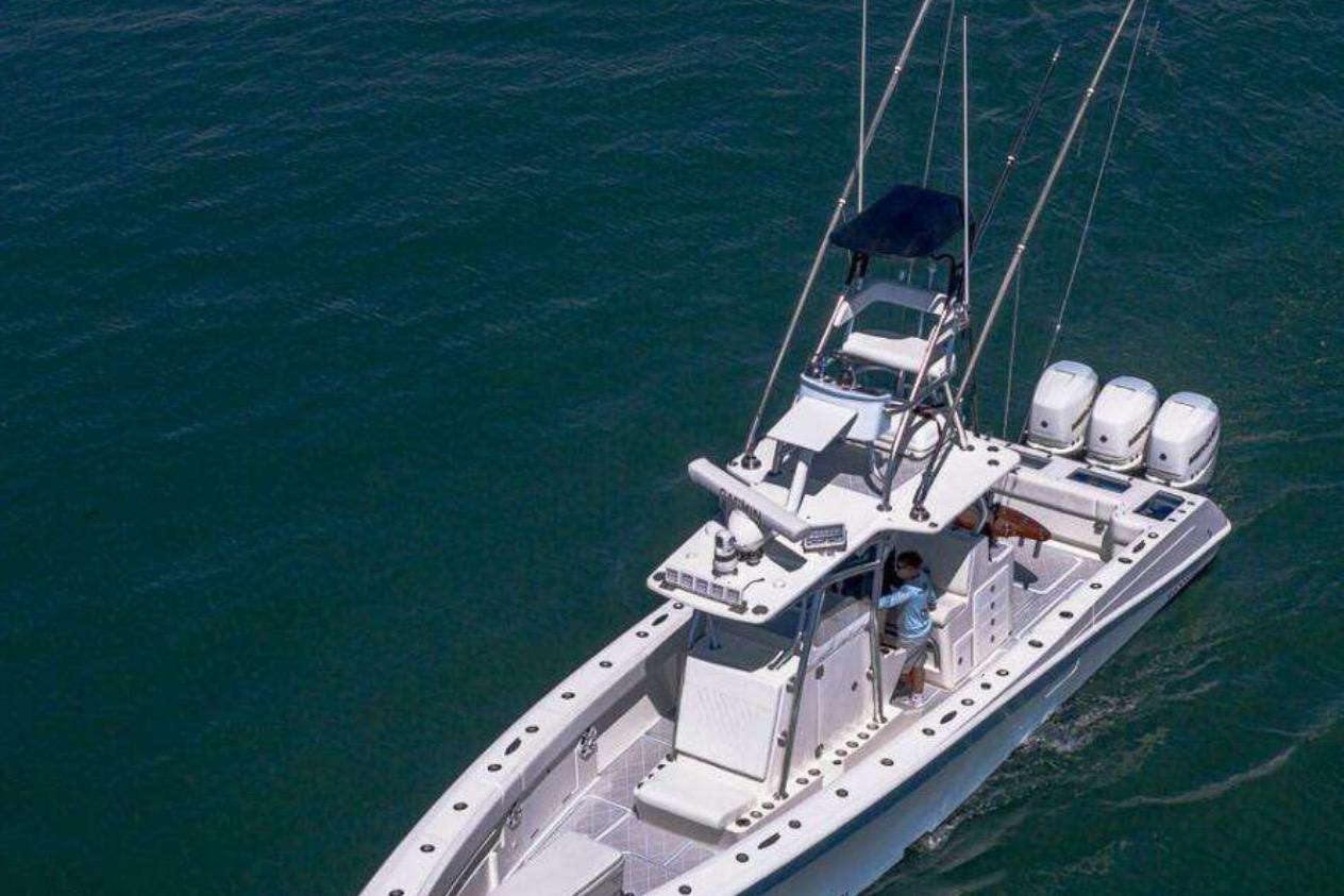 2019 Concept 392 ProFish boat cruising on open water, featuring multiple outboard engines.