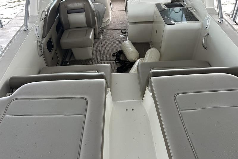 Interior of a 2011 Sea Ray 300 SLX boat with seating and kitchenette.