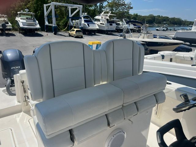 The image shows the cockpit of a Pursuit S268 boat with white seats and a steering wheel.
