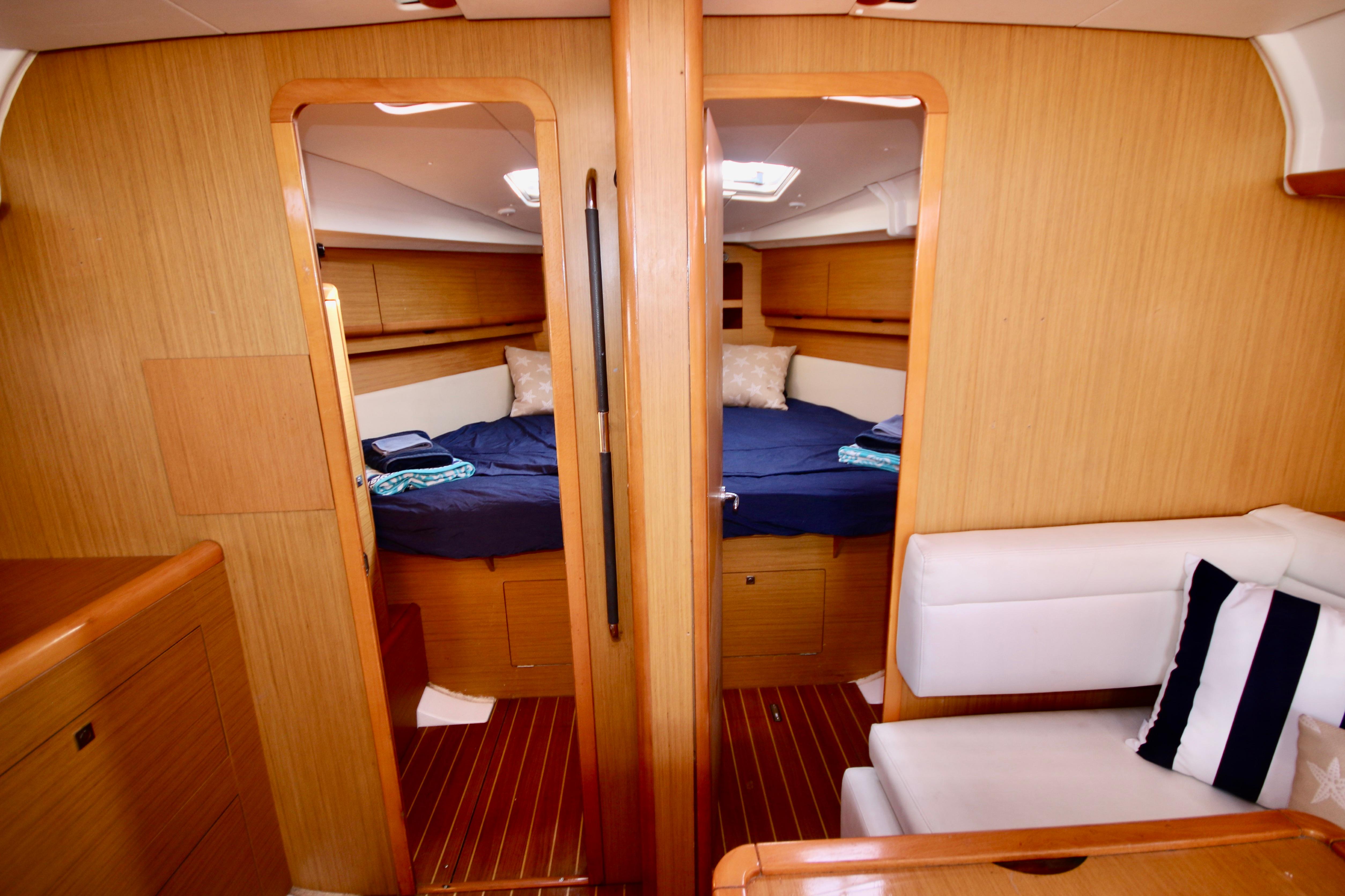Interior of 2009 Jeanneau Sun Odyssey 44i yacht with cozy cabin and seating area.