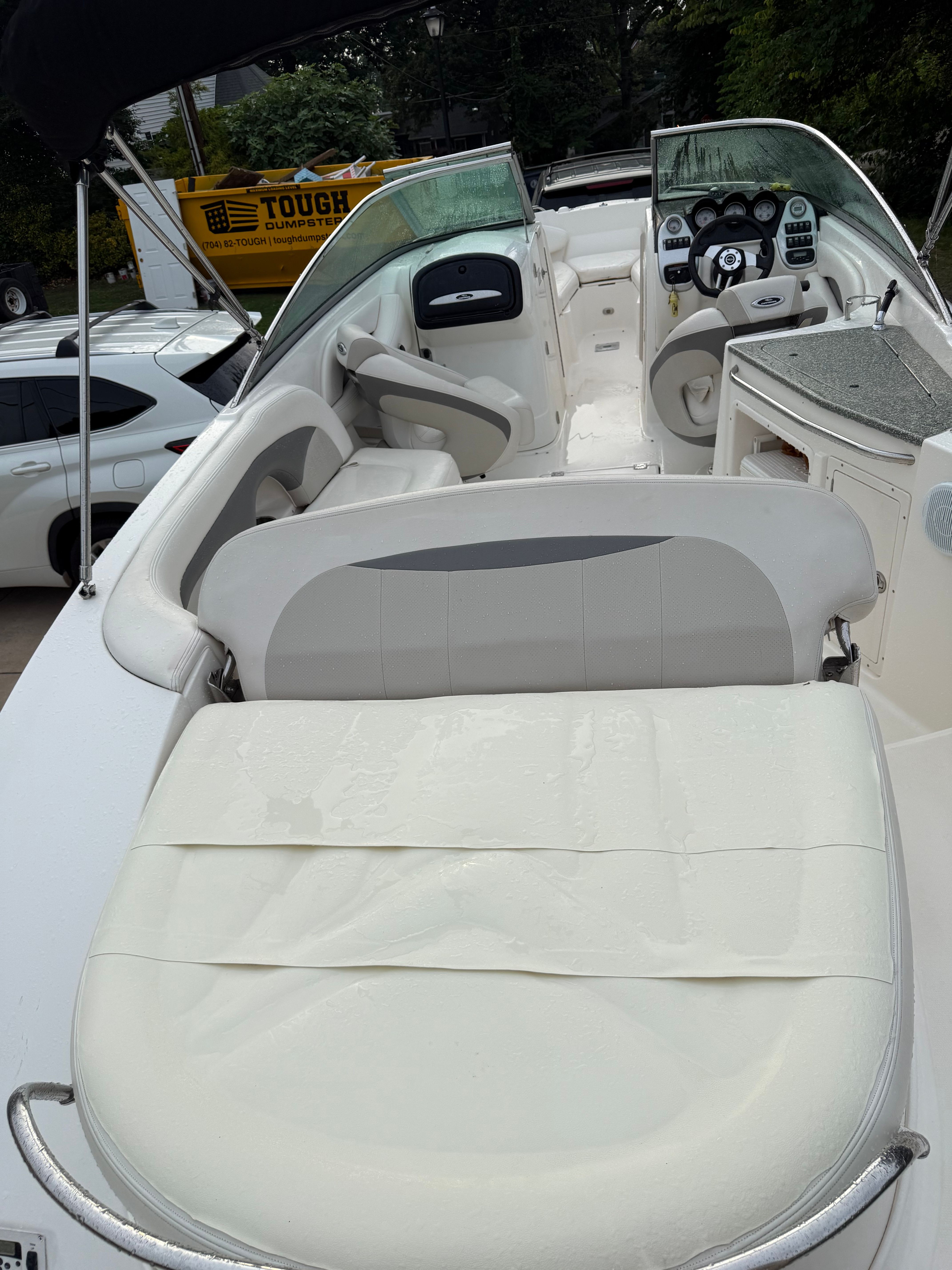 The image shows the cockpit of a 2007 Chaparral 256 SSX boat with white seating.