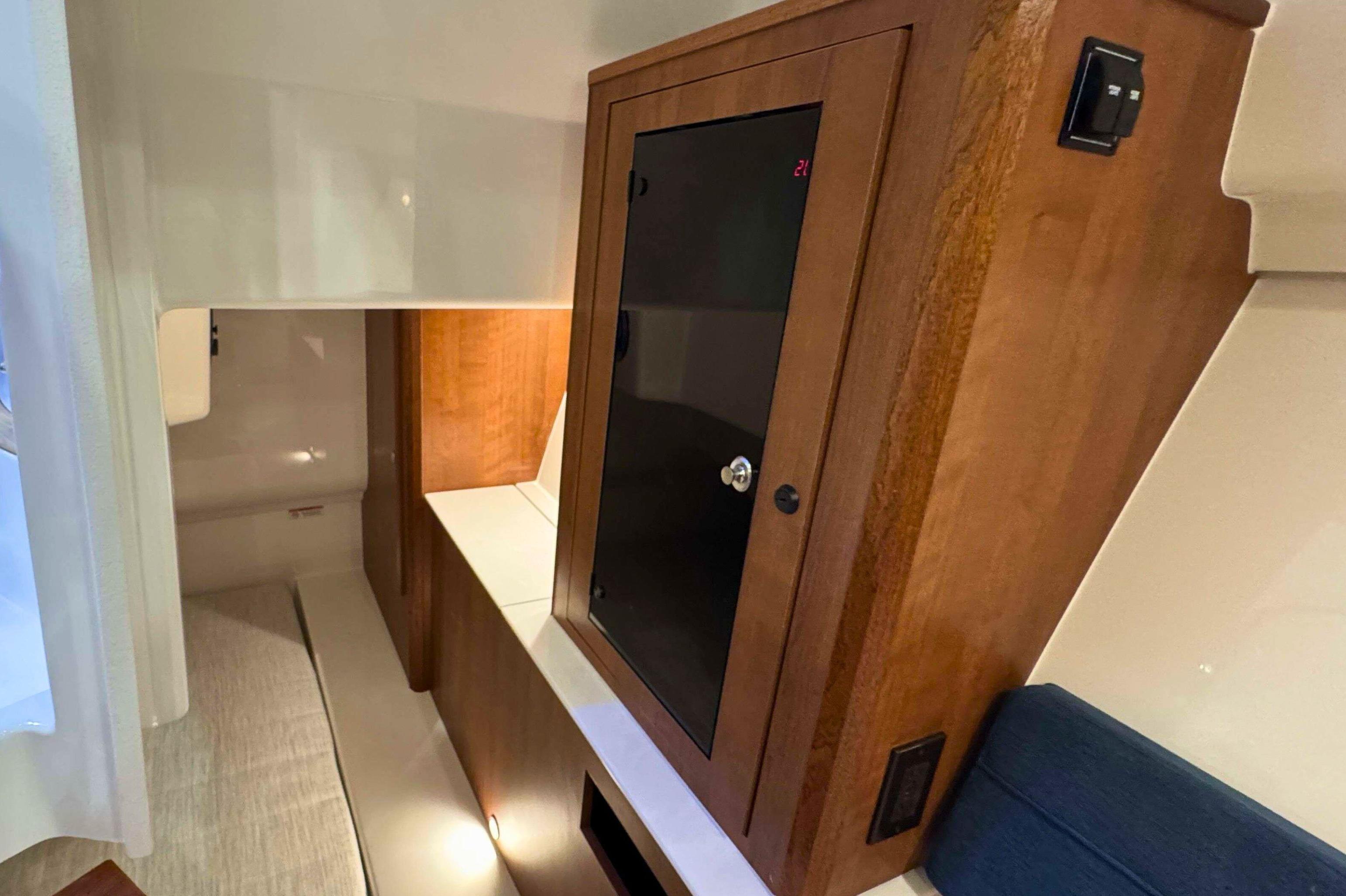 2026 Pursuit DC 365 Dual Console interior with wooden cabinetry and modern design.