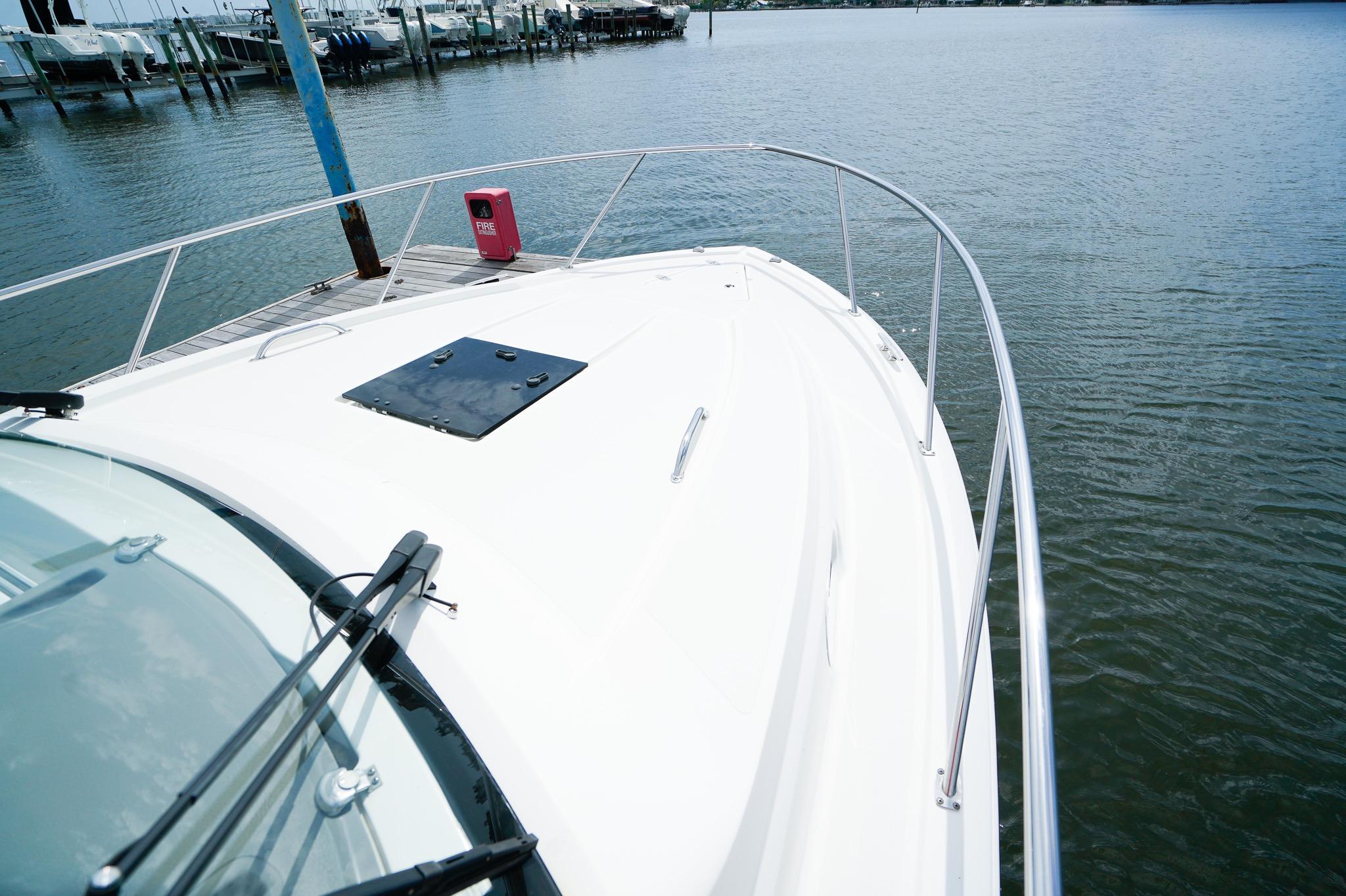 2020 Pursuit OS 325 Offshore boat docked, showcasing sleek design and spacious deck.