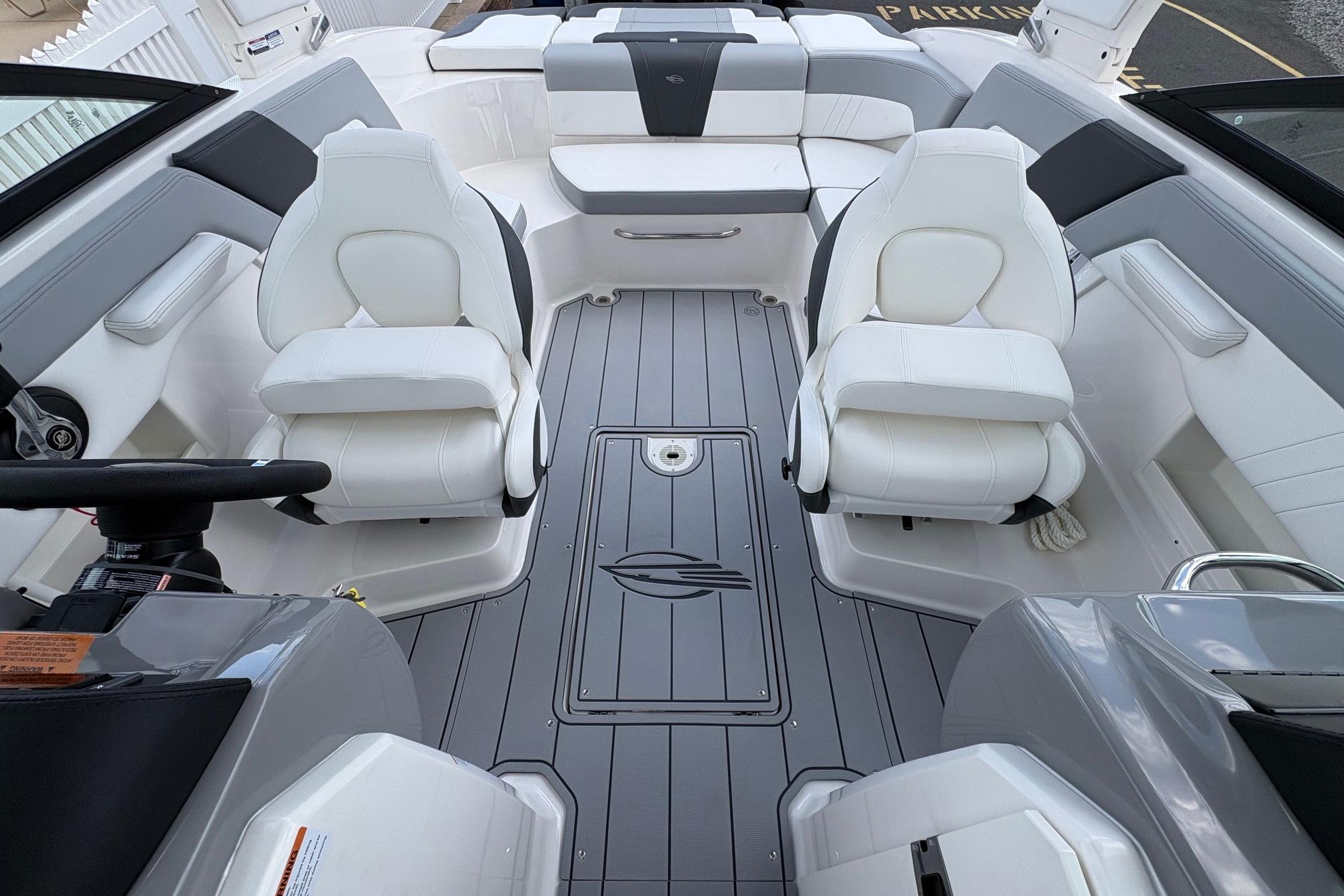 Interior of 2026 Chaparral 23 SSi OB boat with white seating and sleek design.