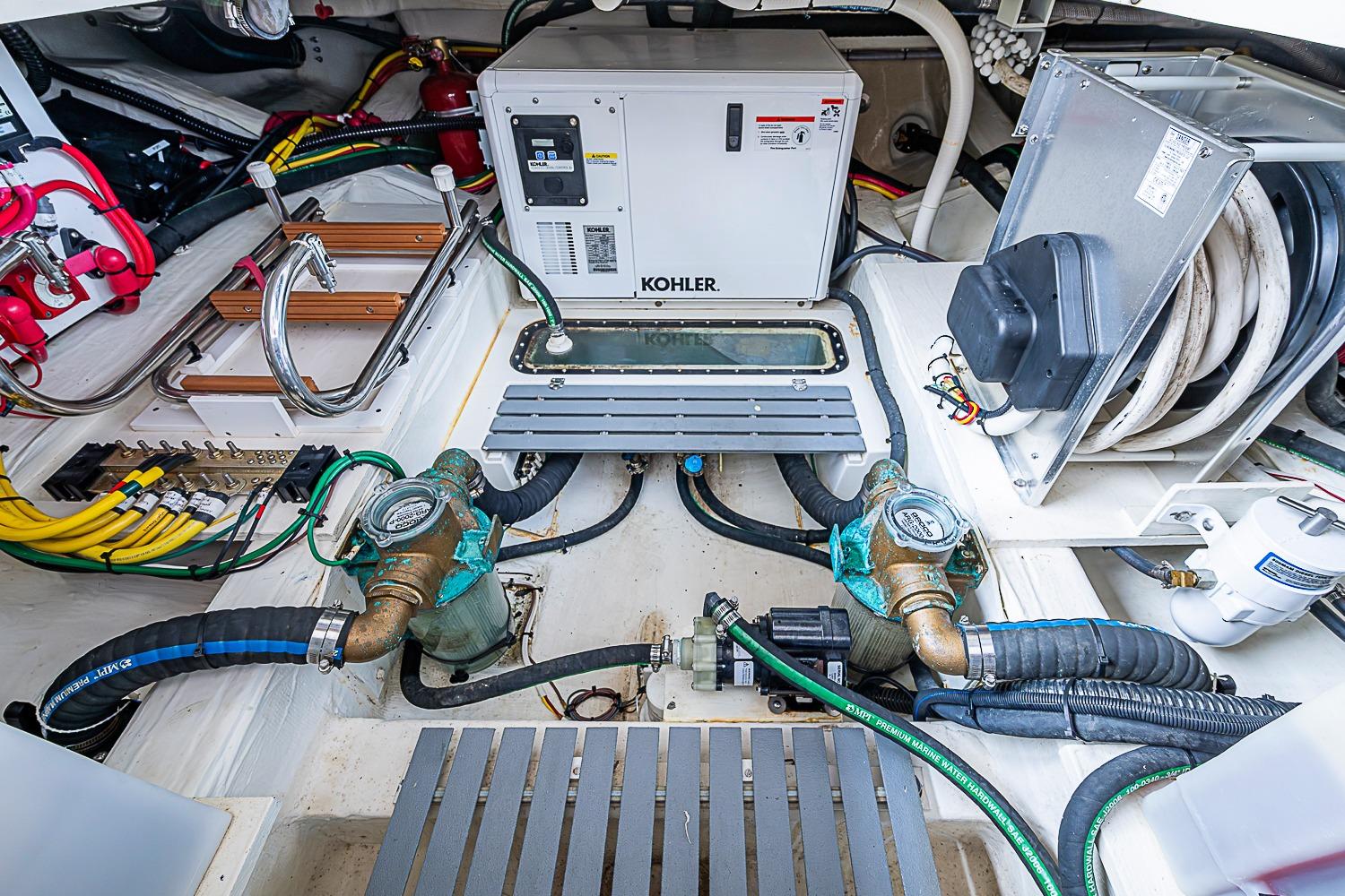 Engine room of 2023 Hinckley Sport Boat 40 X with Kohler generator and wiring.
