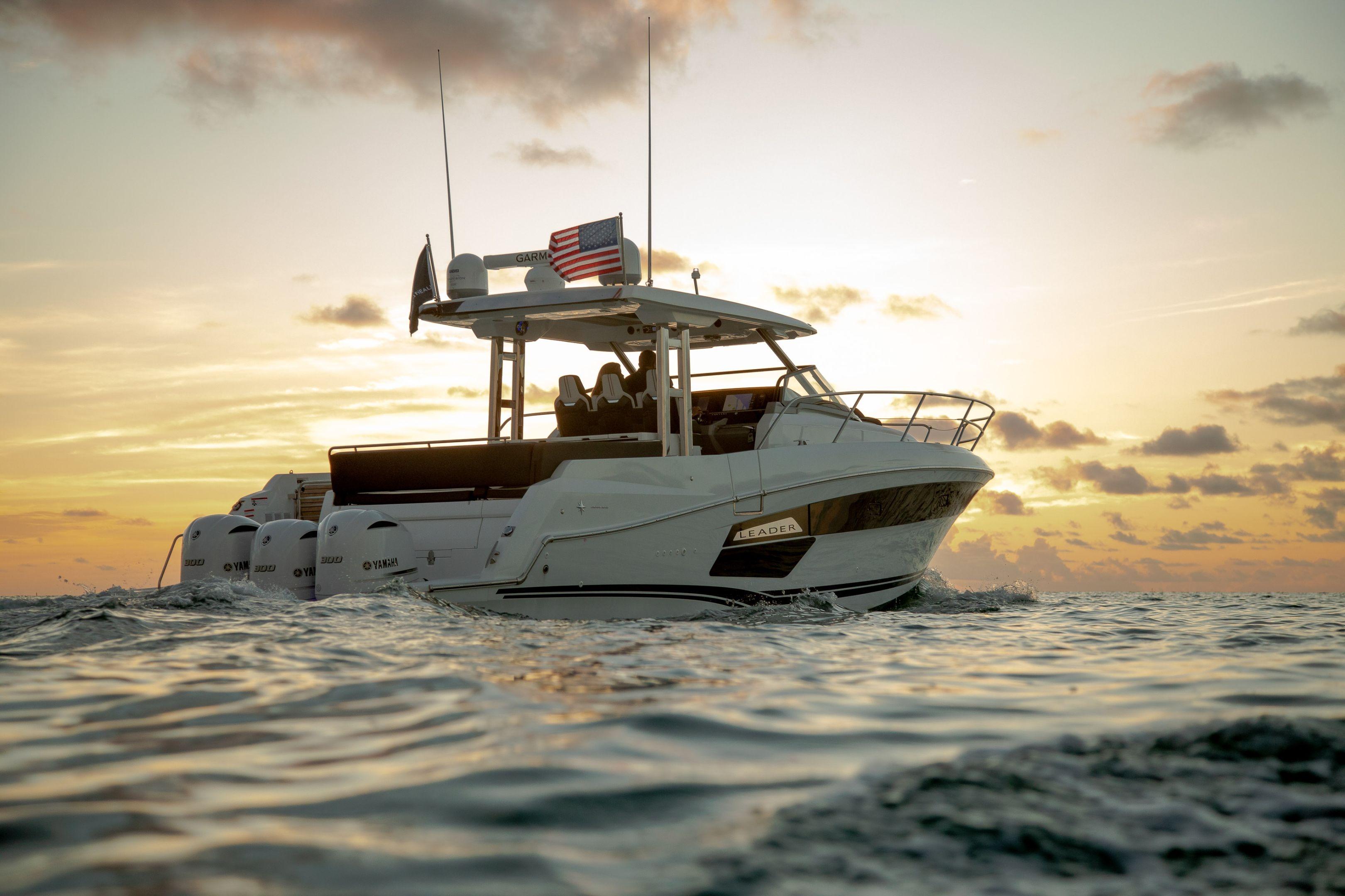 2026 Jeanneau Leader 12.5 WA boat cruising at sunset on open water.