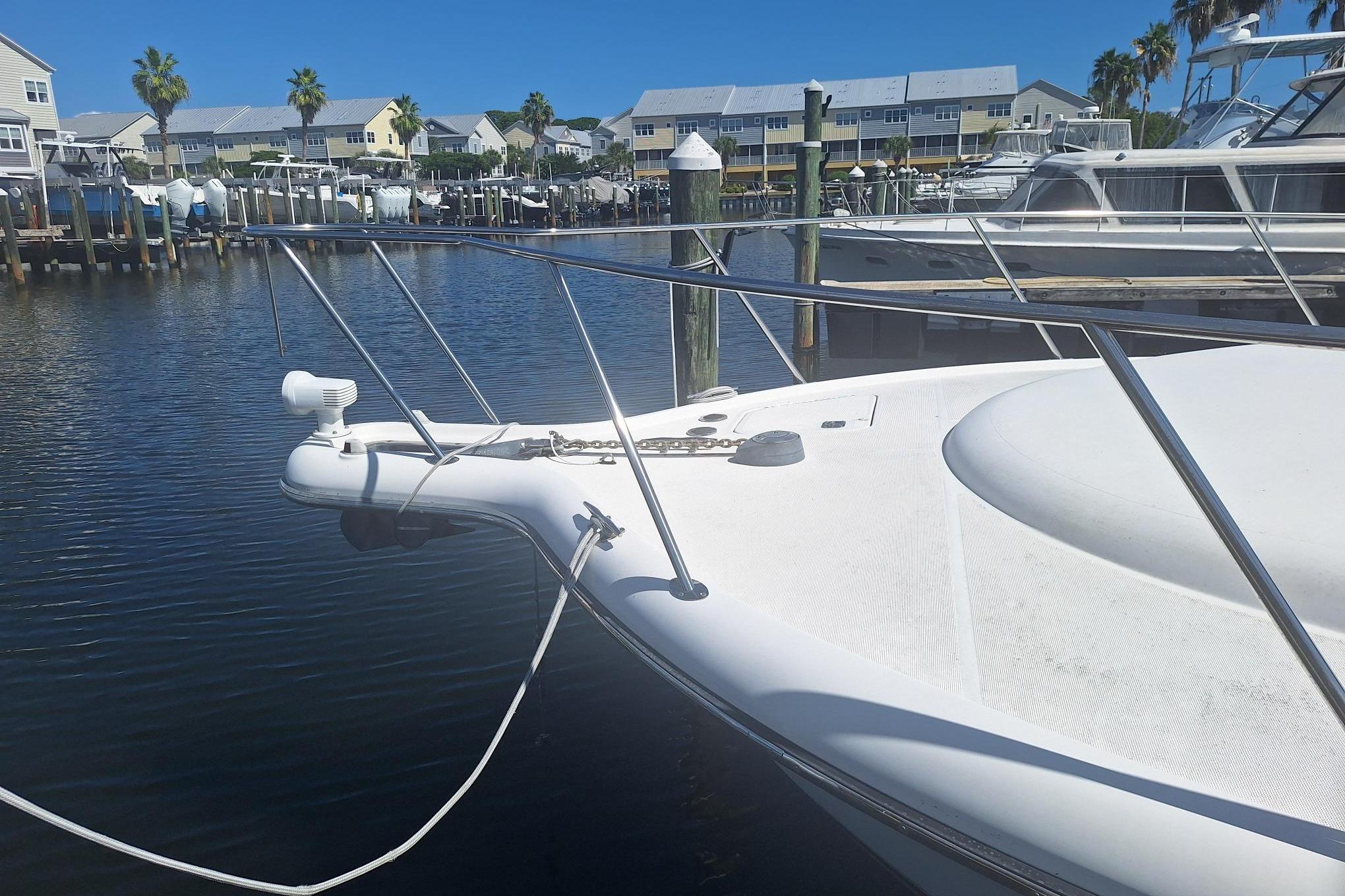 2002 Tiara Yachts 3500 Open docked in a marina with waterfront homes.