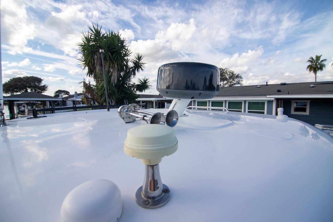 2014 Boston Whaler 315 Conquest boat deck with radar and clear sky.