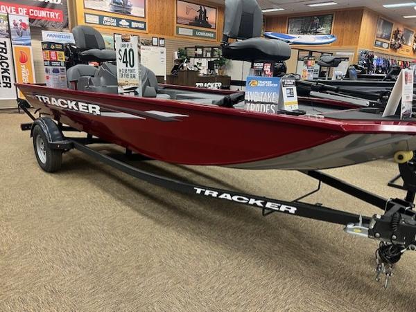 2025 Tracker Pro 170 boat displayed in showroom, red exterior, on trailer.