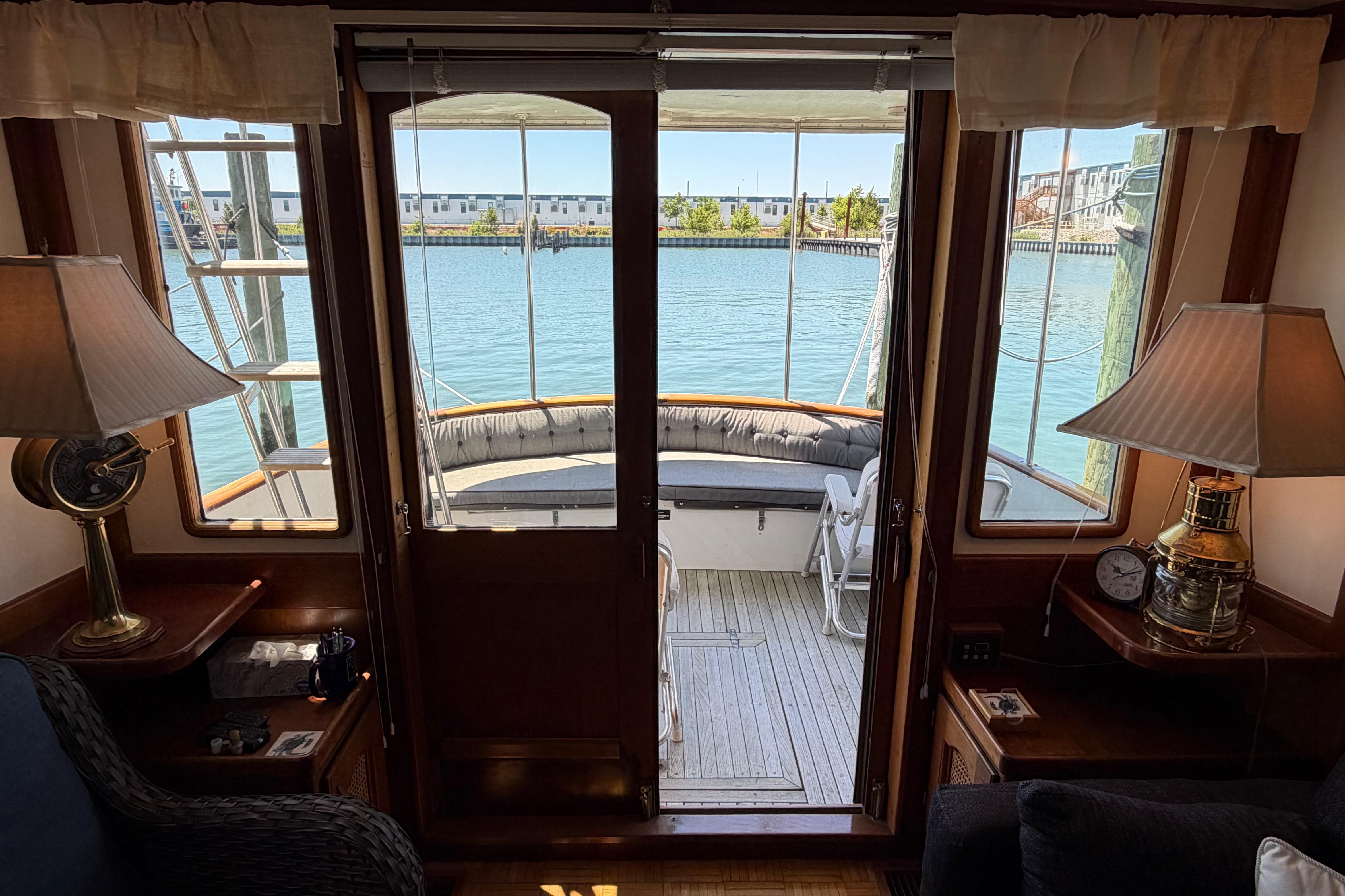 Interior view of 1985 Gozzard PILGRIM yacht with water and dock in background.