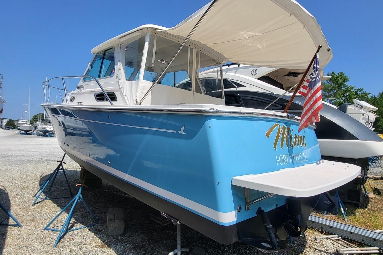 2006 Back Cove 29 boat in dry dock, Fort Myers, FL, with American flag.